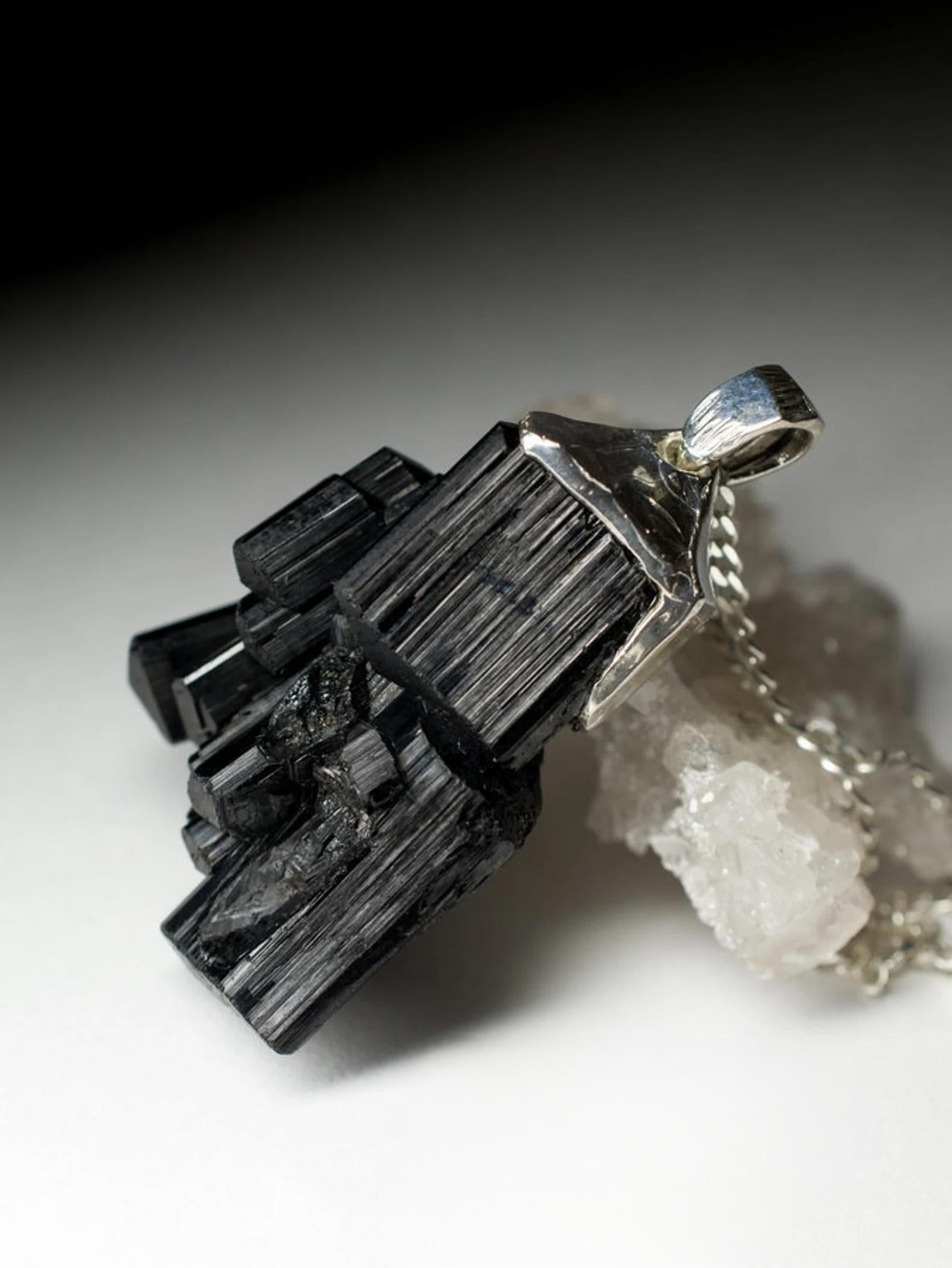 Silver pendant with natural raw Crystal Cluster of Black Tourmaline 
Tourmaline gemstone origin - Namibia
gem size is 0.71 х 0.98 х 1.5 in / 18 х 25 х 38 mm
stone weight - 94 carat
pendant weight - 24.62 grams
pendant length - 1.85 in / 47