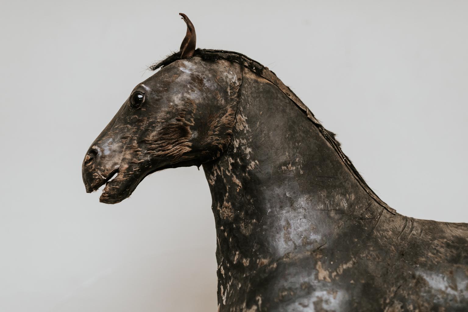 Naive and very charming French toy horse, leather covered with pony hair.