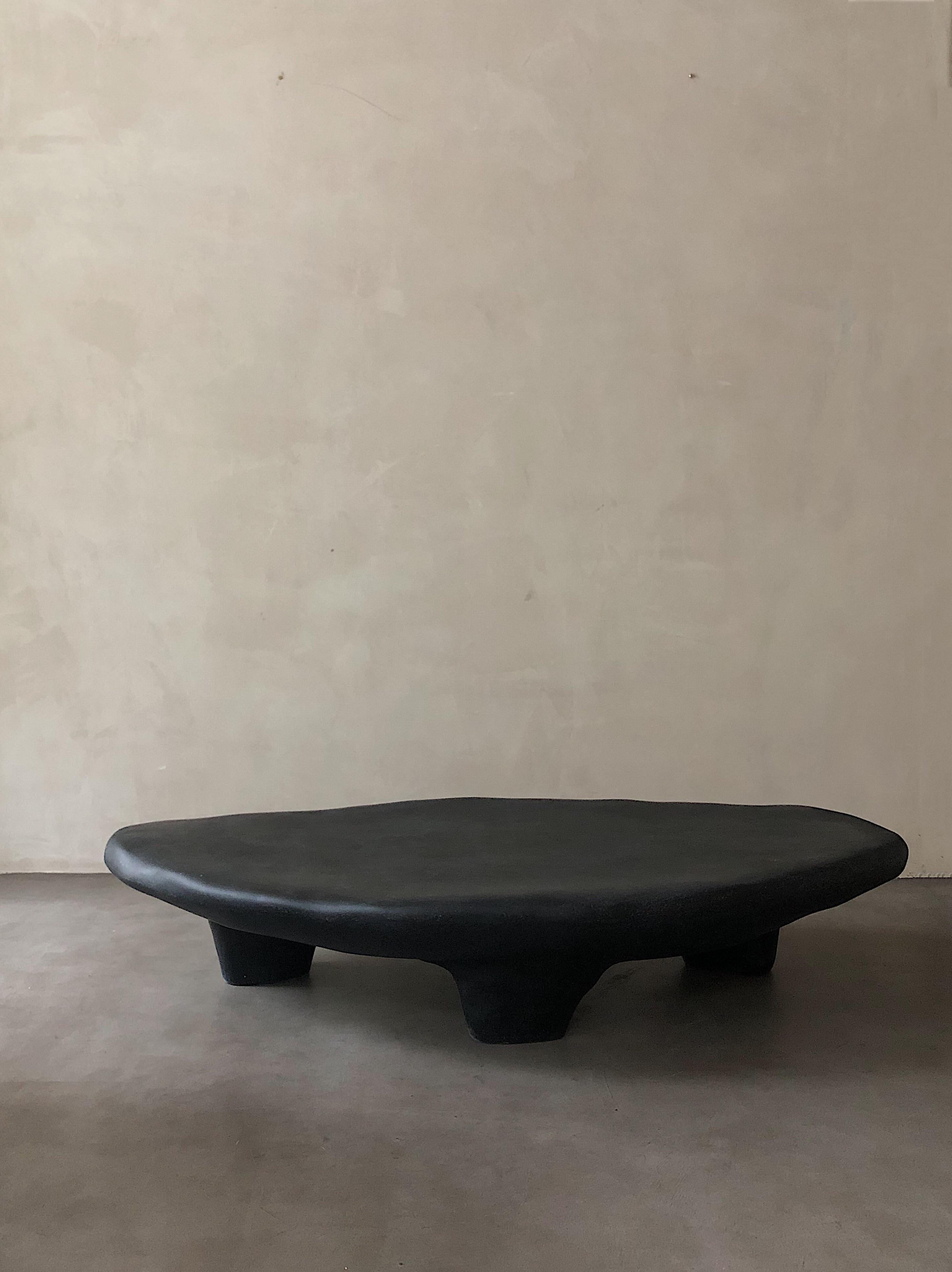 Black Tripod Coffee Table by Karstudio.
Materials: FRP.
Dimensions: 150 x 85 x 30 cm.
*This piece is suitable for outdoor use.

Inspired by three-leg utensils, which were the first creation of human beings in ancient times. The triangle structure