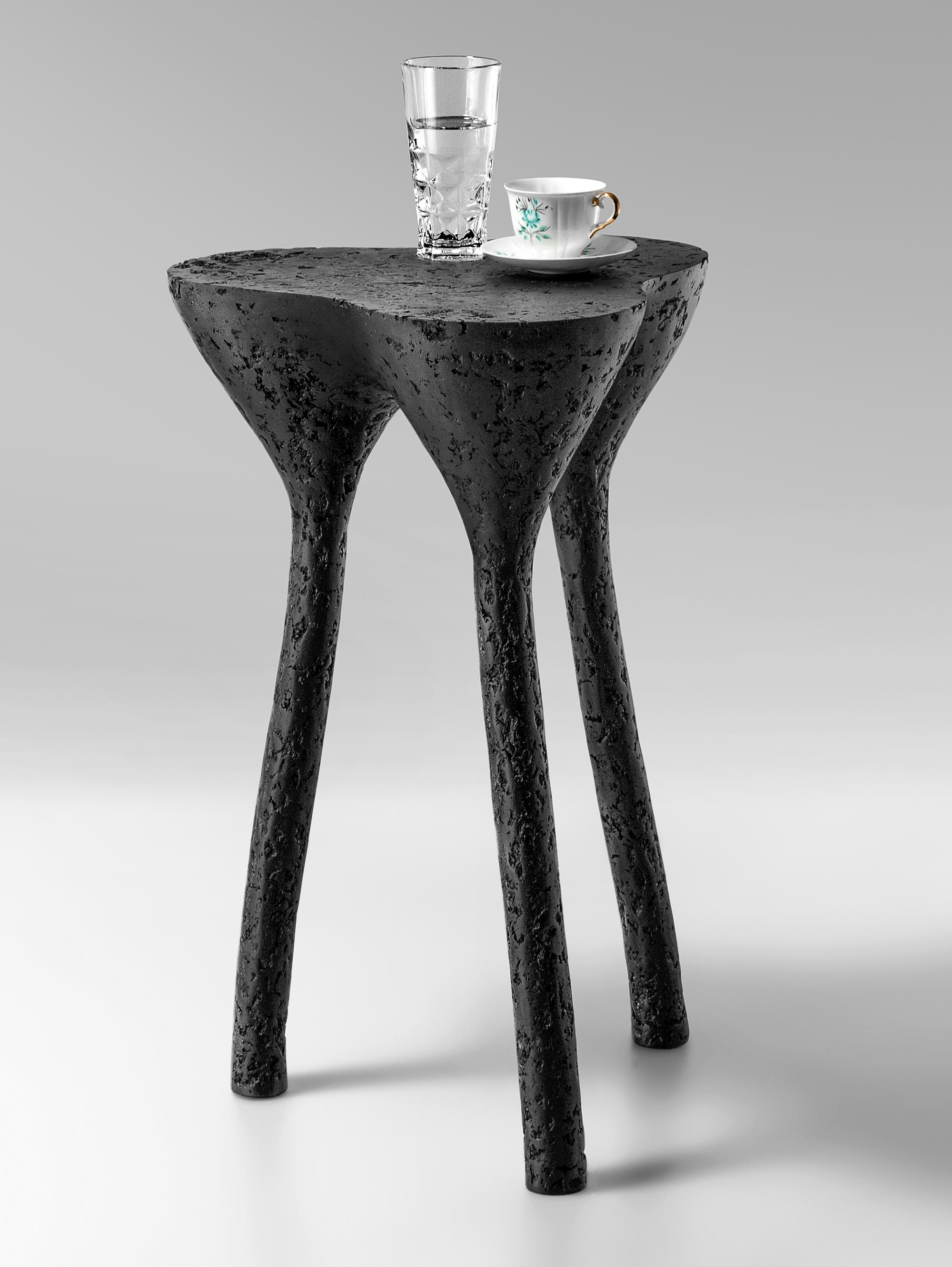 Black Tripod Side Table by Kasanai
Dimensions: D 38 x H 65 cm.
Materials: Cement, wood, recycled paper, glue, paint.
6 kg.

The fusion of sturdiness and elegance, along with the blend of archaism and modernity. More than just a surface for placing