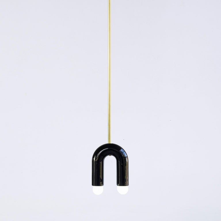 TRN A1 pendant lamp by Pani Jurek
Dimensions: D 5 x W 15 x H 18 cm 
Material: ceramic and brass.
Available in other colors.
Lamps from the TRN collection hang on a metal tube, not on a cable. This allows the lamp to be mounted in a specific