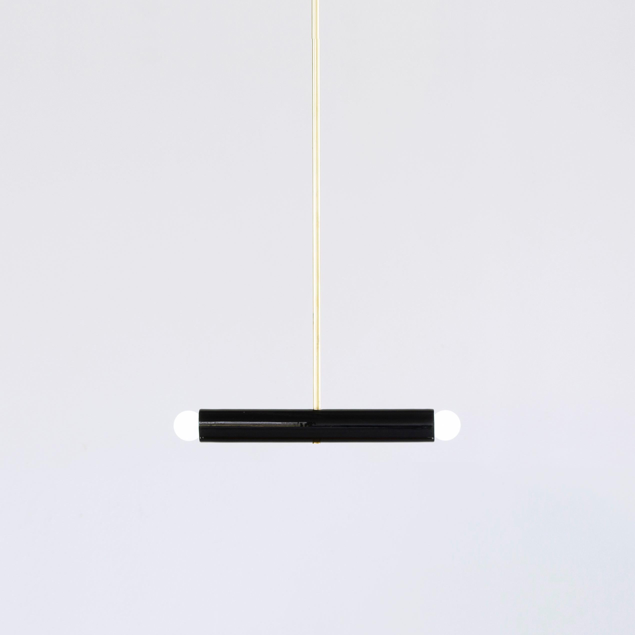 Black TRN A2 pendant lamp by Pani Jurek
Dimensions: D 5 x W 35 x H 5 cm 
Material: Hand glazed ceramic and brass.
Available in other colors.
Lamps from the TRN collection hang on a metal tube, not on a cable. This allows the lamp to be mounted in a
