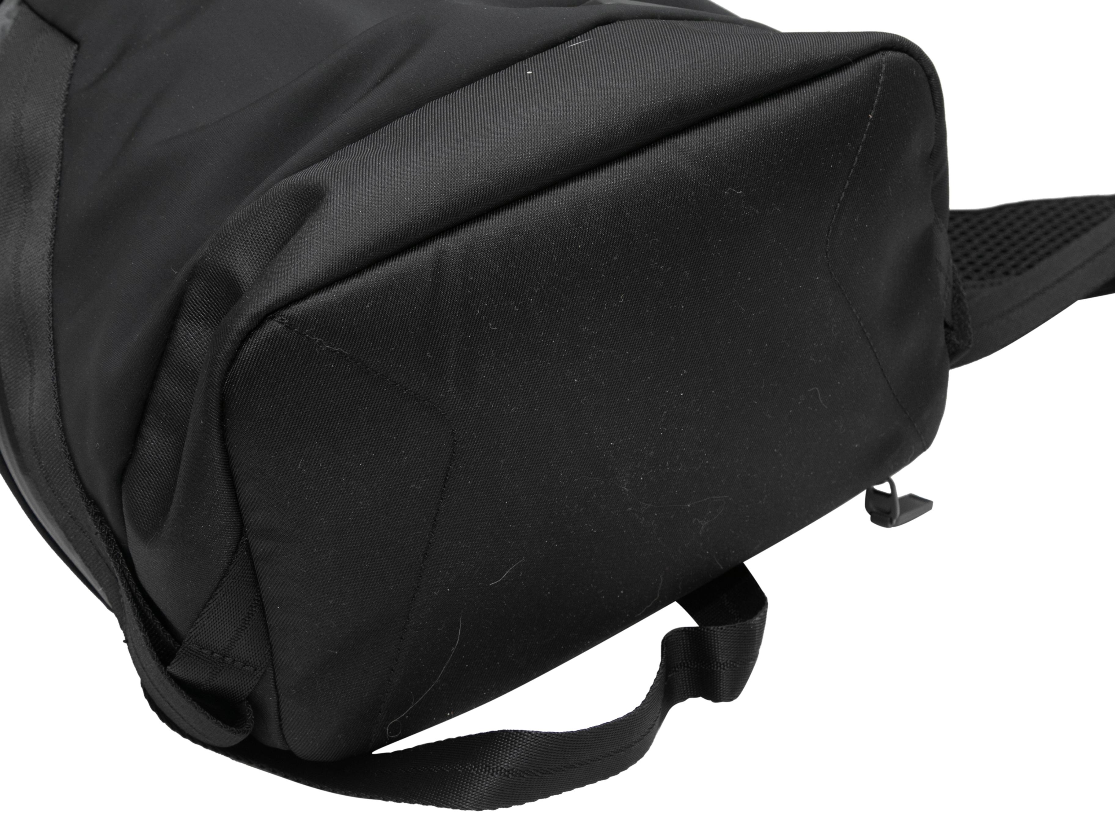 Black Tumi Tahoe Nylon Backpack. The Tahoe backpack features a nylon body, dual front side zip pockets, a padded back, dual adjustable shoulder straps, and a top zip closure. 14