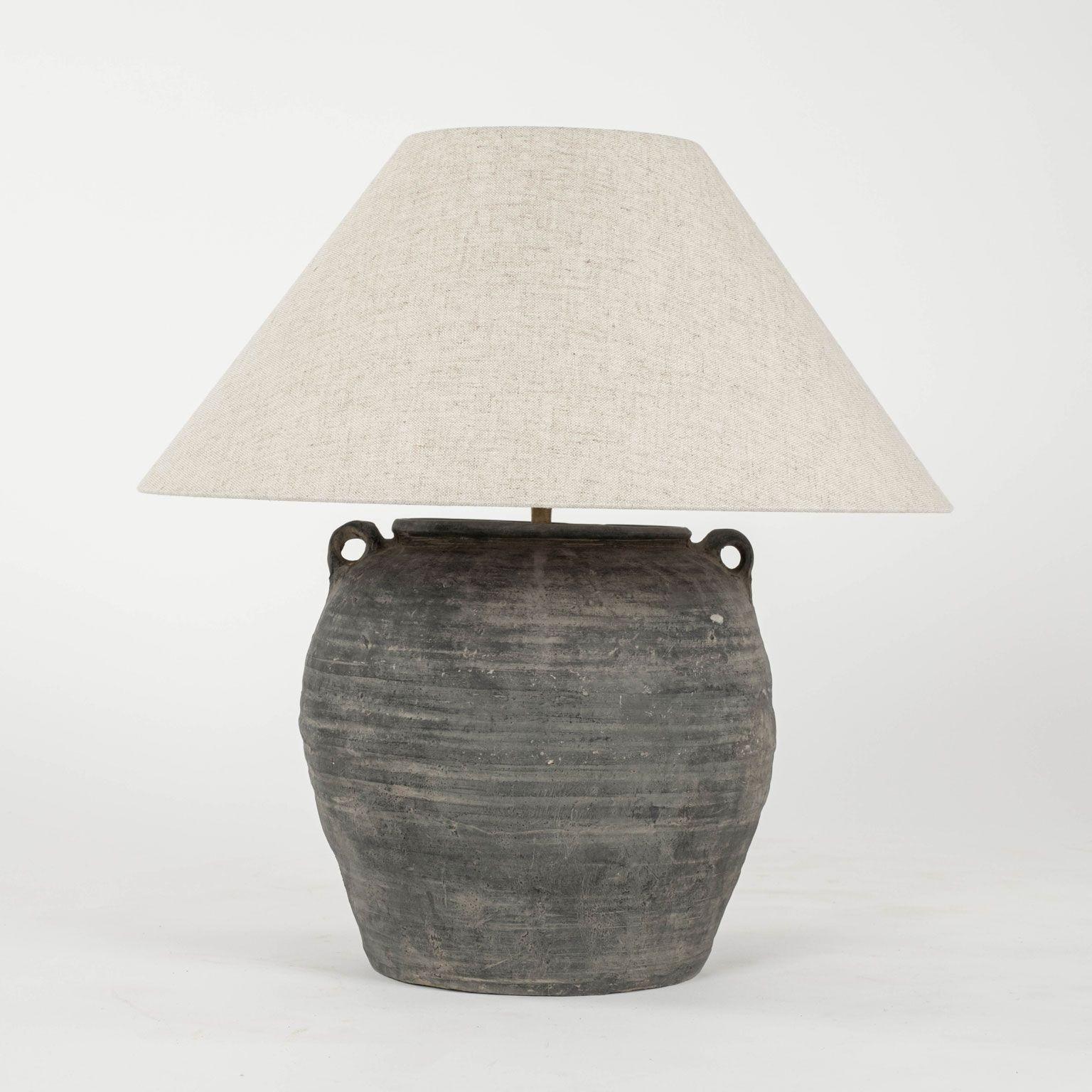 Black unglazed lamp with handles and linen shade. Hand-made ceramic jar, newly wired as custom table lamp. Lamp measures 22.5 inches high and 21.5 inches diameter (with shade), and without a shade the diameter is 13 inches and height is 15.5 inches