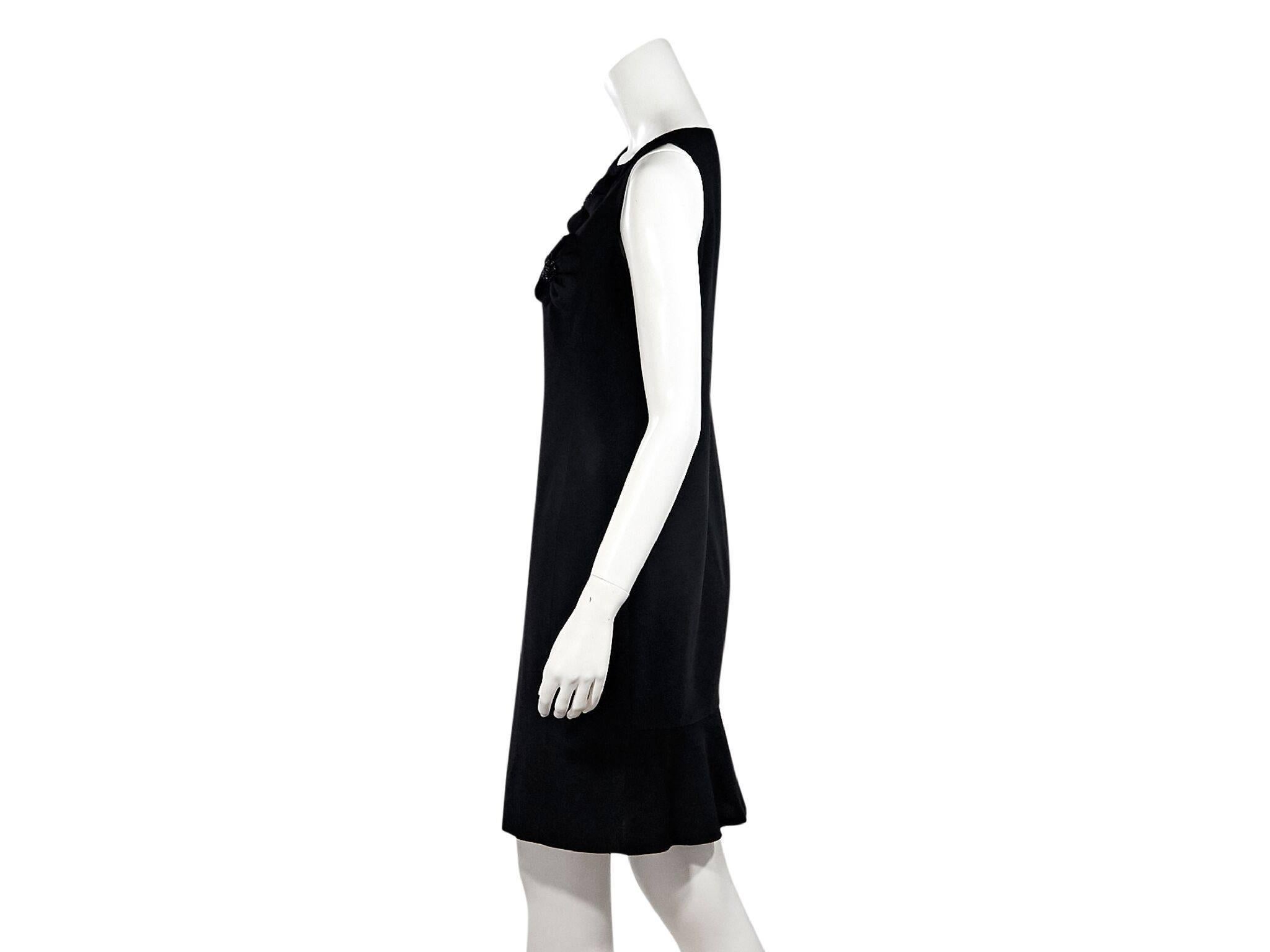 Product details:  Black wool sheath dress by Valentino.  Accented with tonal embellished floral applique.  Asymmetrical v-neck.  Sleeveless.  Concealed back zip closure.  38