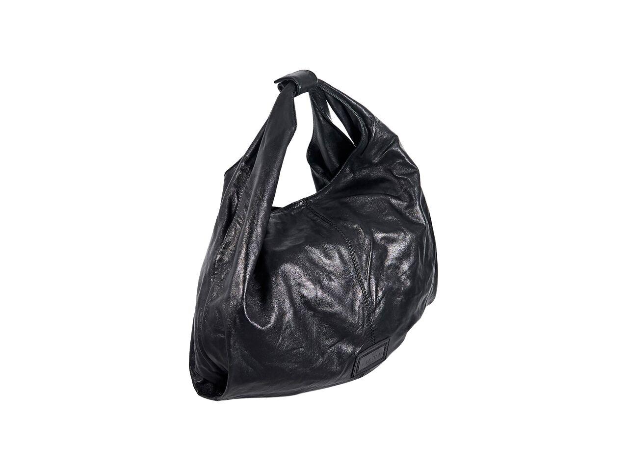 Product details:  Black leather hobo bag by Valentino.  Accented with oversized floral applique at front.  Single shoulder strap.  Concealed magnetic snap closure.  Lined interior with inner zip and slide pockets.  19