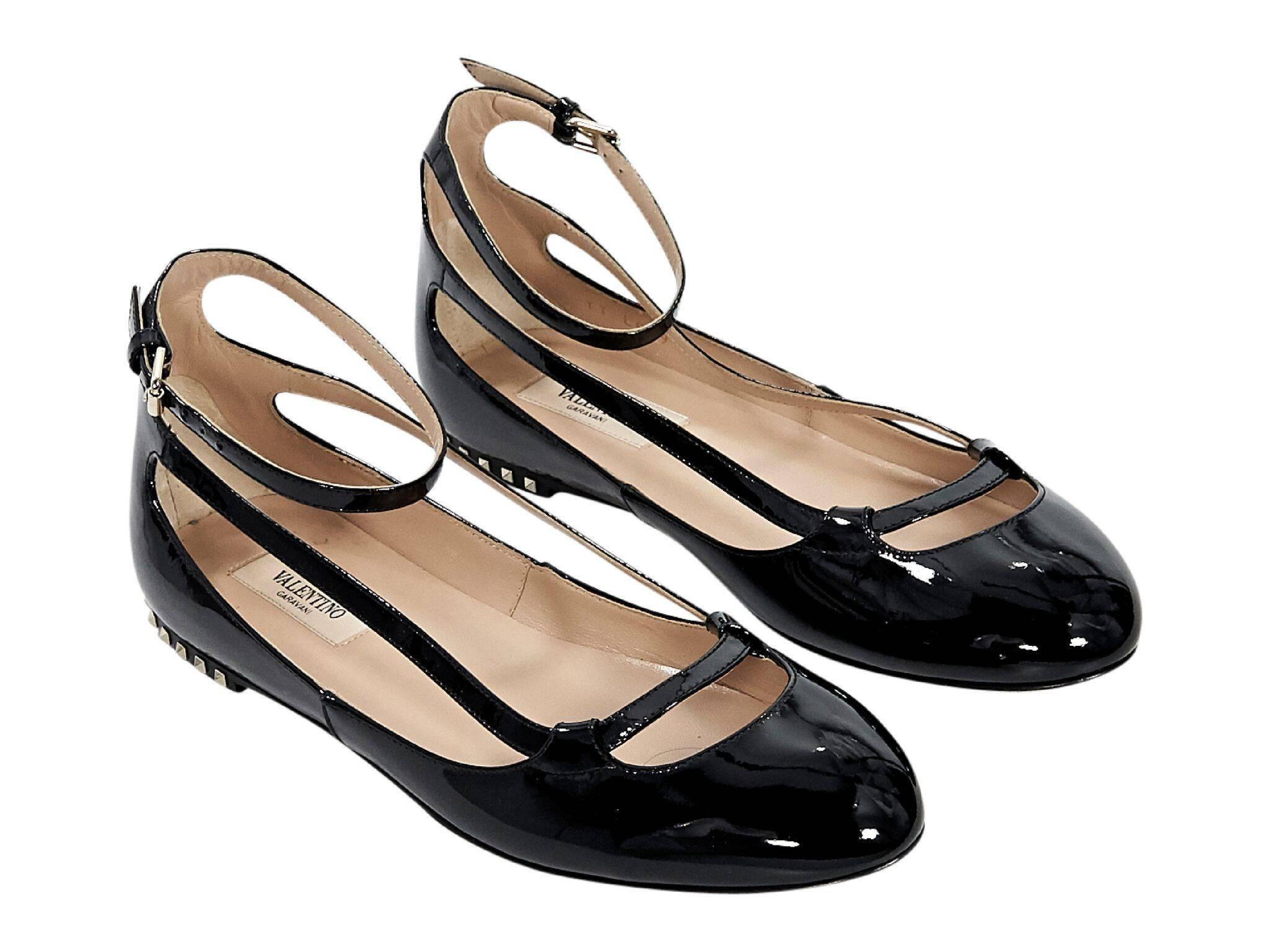 Product details:  Black patent leather ballet flats by Valentino.  Accented with pyramid studs.  Adjustable ankle strap.  Round toe.  Goldtone hardware.
Condition: Pre-owned. Very good.
Est. Retail $995