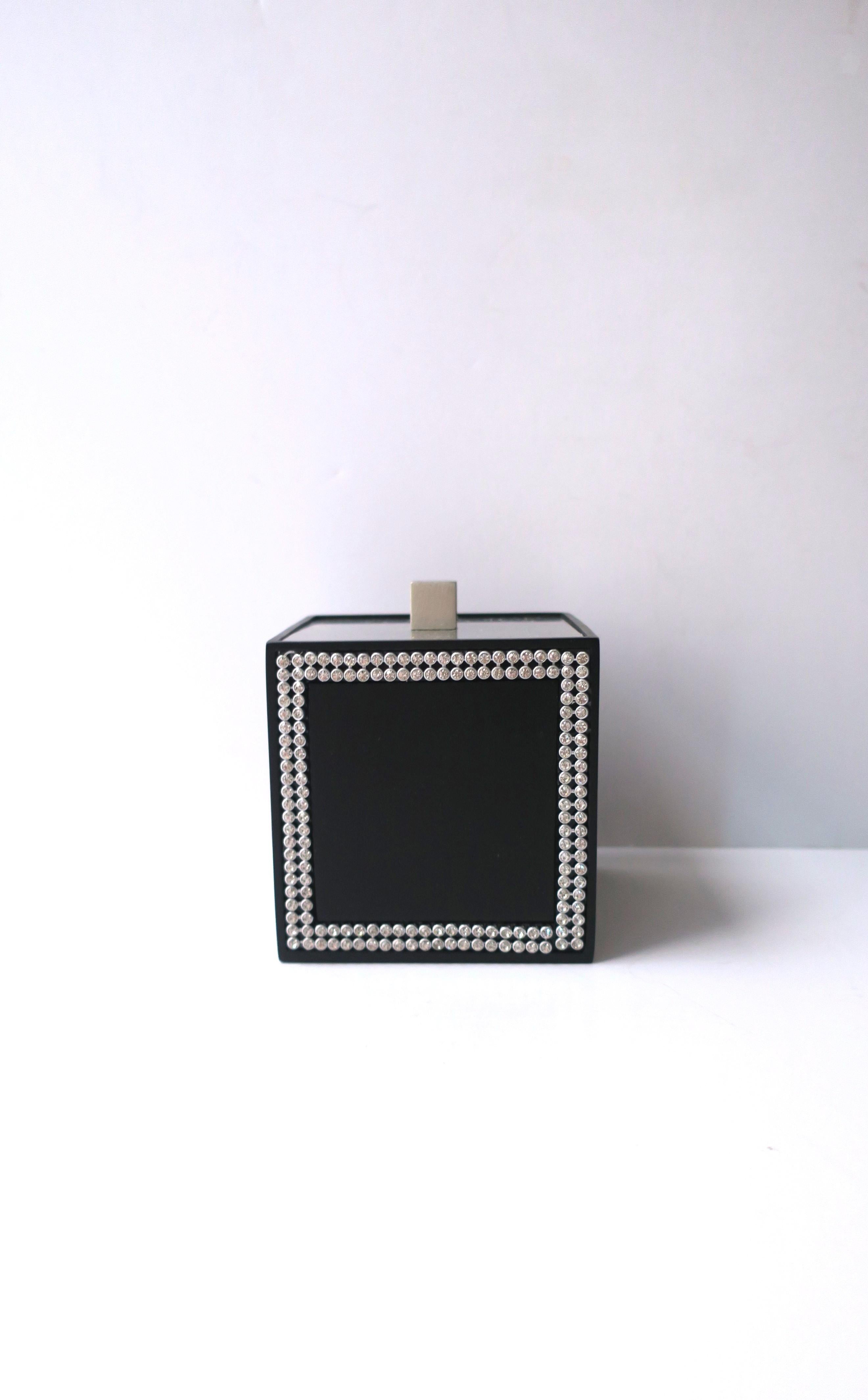A black vanity box with faux-diamond design. Box is a black powder-coated metal with faux diamond design, on two sides, finished with a metal lid with square knob. Piece has never been used. A great piece for a vanity, bathroom, powder room, walk-in
