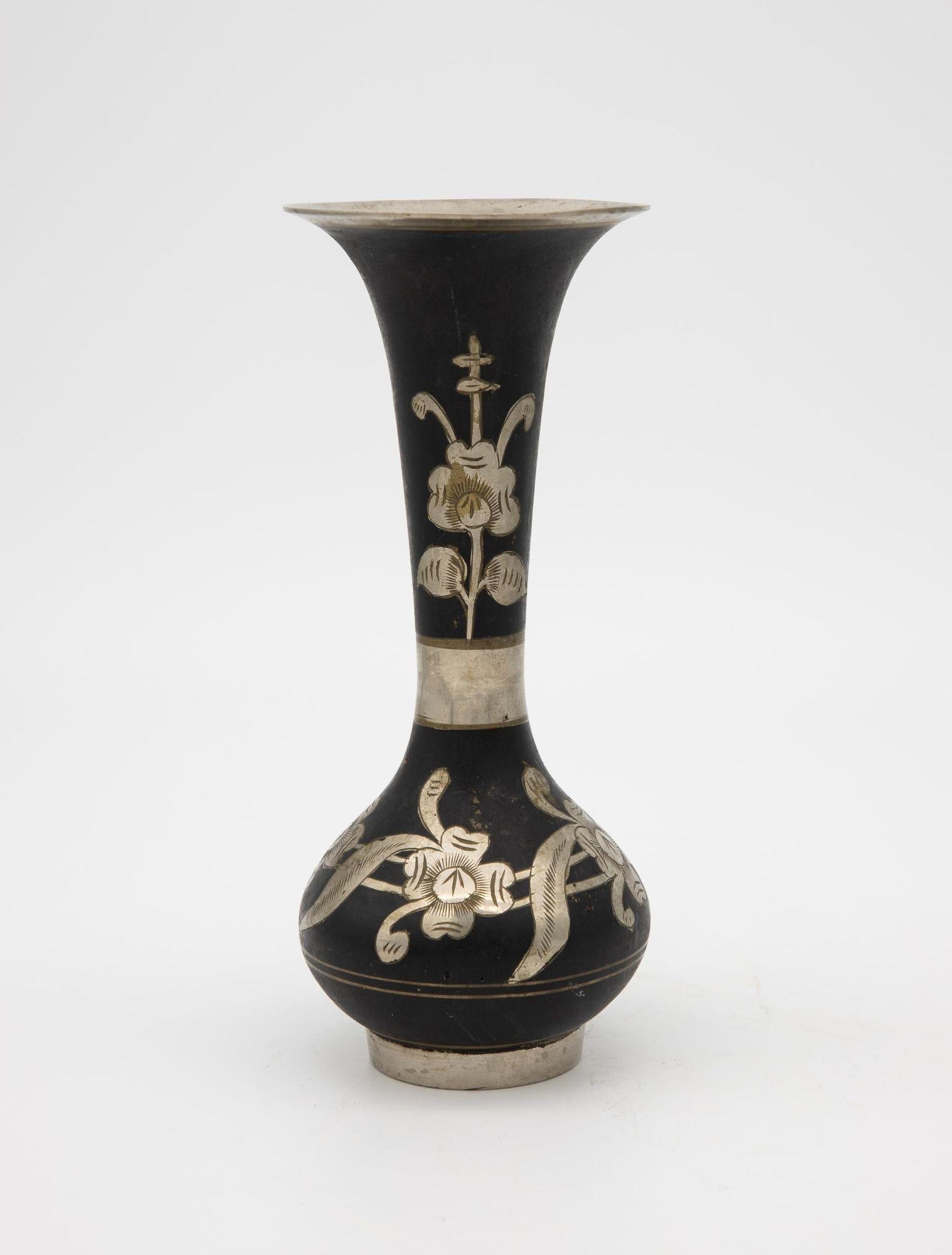 A 1970s black vase with etched floral detail and band. Asian influence.