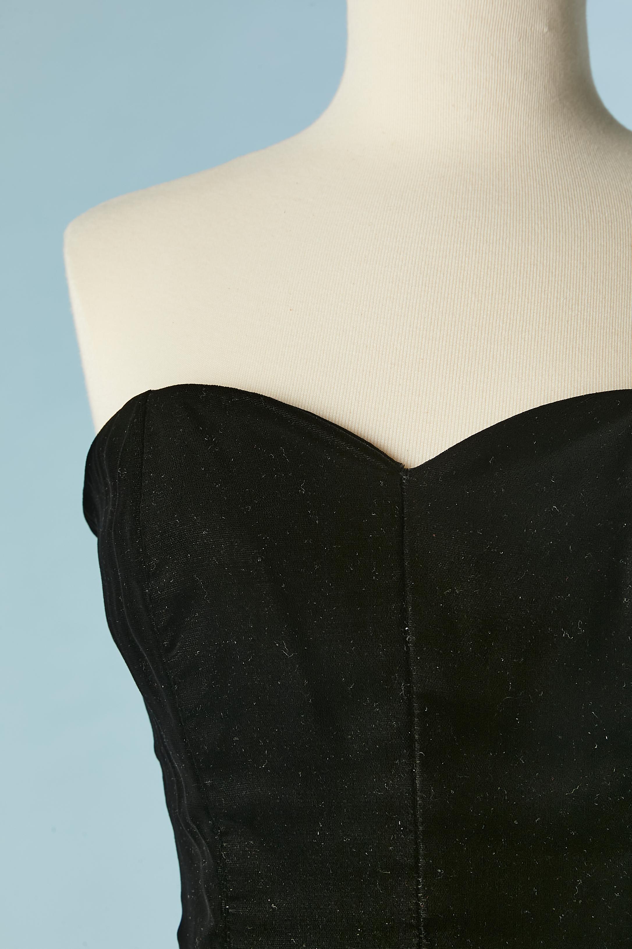 Black velvet bustier evening dress with furs around the waist. No fabric tag composition but the lining is probably in rayon and the fur is fox. 
Zip and hook&eye in the middle back. Boned. The skirt is wrap on the middle front. 
SIZE M 