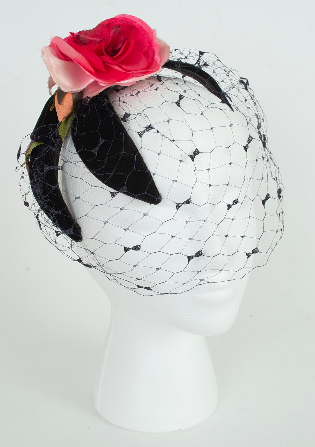 A hat that would make Isabella Blow’s heart flutter, this magnificent fascinator sits atop the head via black velvet “petals” that fan from the crown of the head to the ears. A perfect pink satin rose sits at the top center beneath which a black
