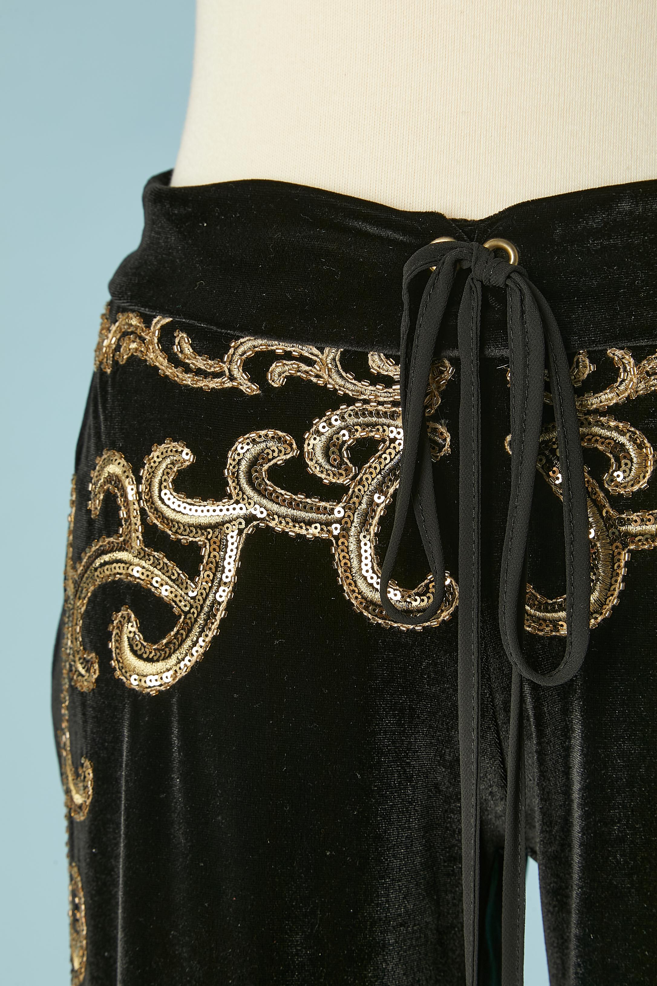 Black velvet jogging pant with gold sequins embroideries. Drawstring waist. Fabric composition: 95% polyester, 5% lycra. 
SIZE 42 (It) L ( with adjustable waist) 