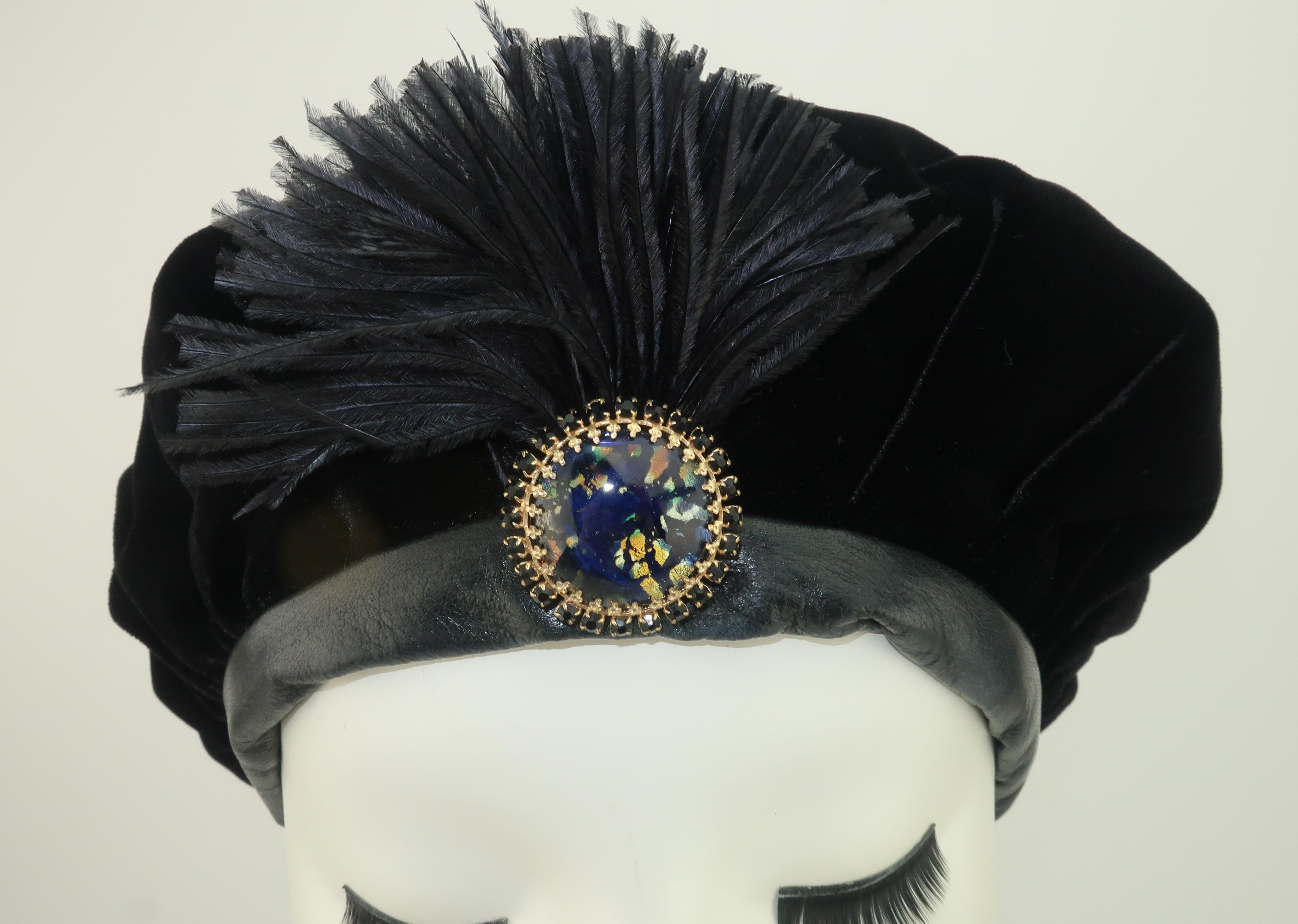 This 1980's hat is loaded with a 1930's personality.  The lush black velvet body is lined with faille fabric and trimmed in supple leather.  The little detail that takes this look from practical to perfect is the reverse blue & gold painted glass