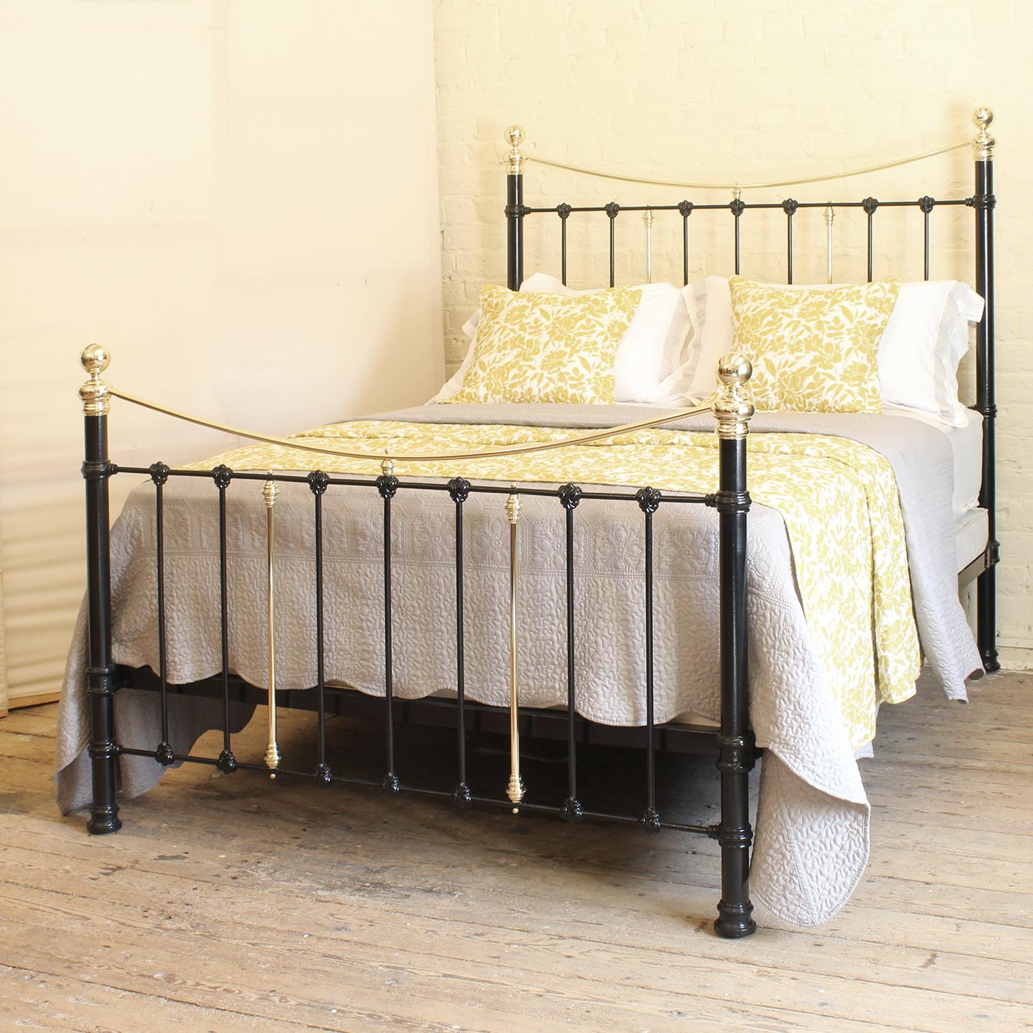 An attractive cast iron Victorian antique bed finished in black with curved brass top rails and decorative castings.

This bed accepts a UK king size or US queen size (5ft, 60in or 150cm wide) base and mattress set.

The price includes a standard