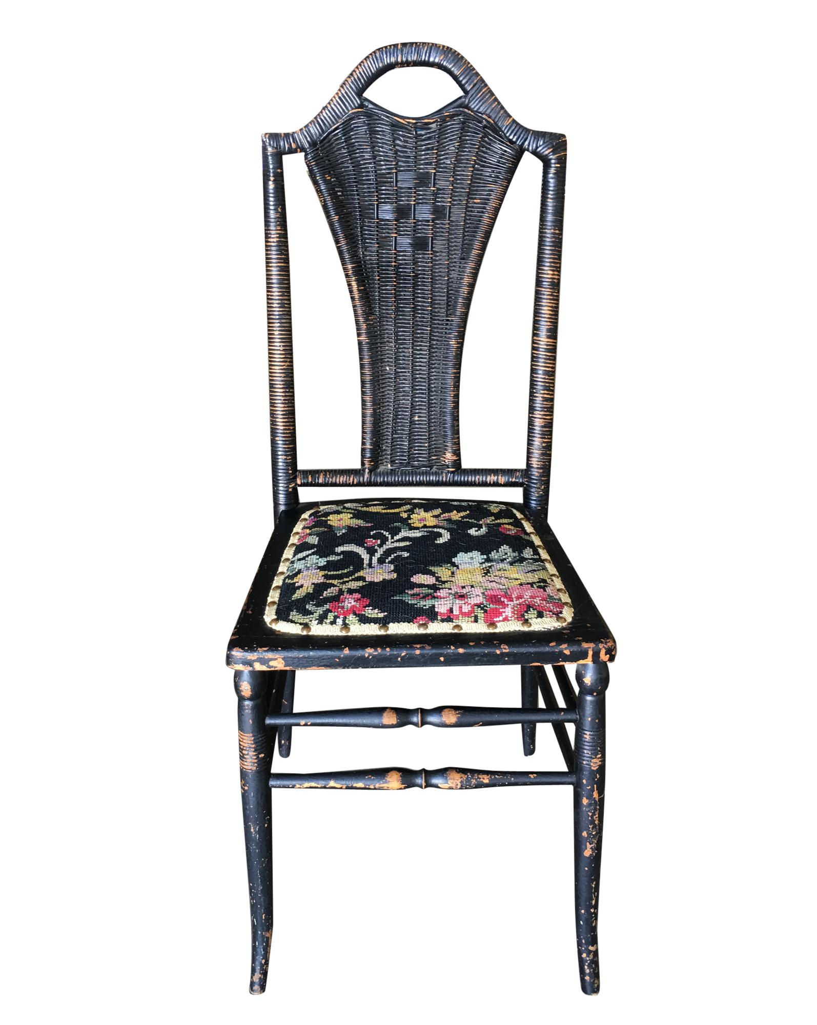 Black Victorian southern Gothic wicker back side chair with a Thonet style sculpted wood frame, needle point seat and woven wicker seat back.