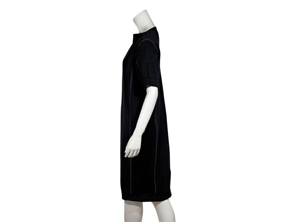 Product details:  Vintage black cotton knit sweater dress by Alaia.  Accented with purple seams.  Boatneck.  Elbow-length sleeves.  Pullover style.  50