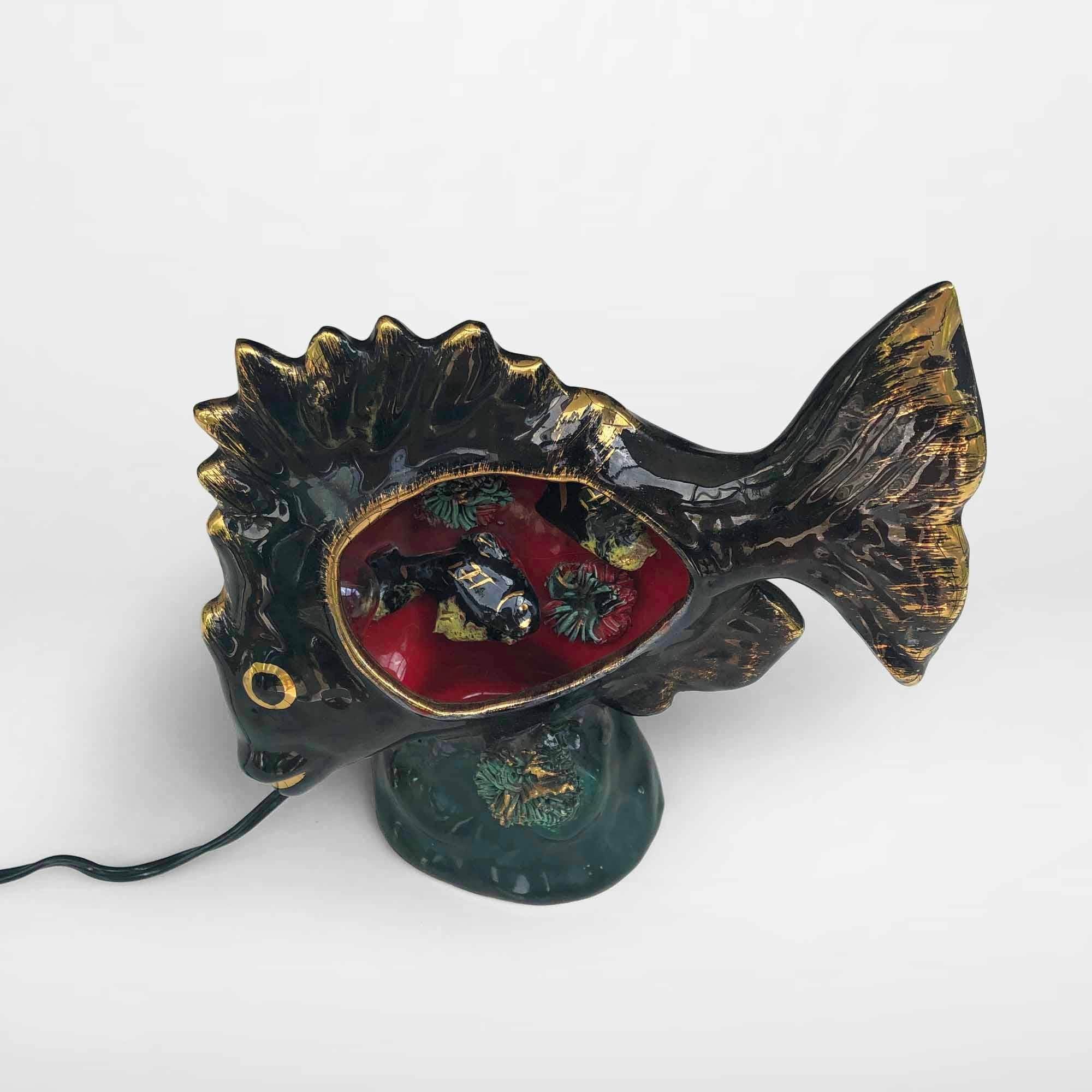 Original 1950s ceramic fish lamp by Vallauris. This type of table lamp exists in many versions, all with fish, shellfish, crustaceans, and starfish. Bright colors with golden details, typical for the 1950s and 1960s. This lamp has a black color with