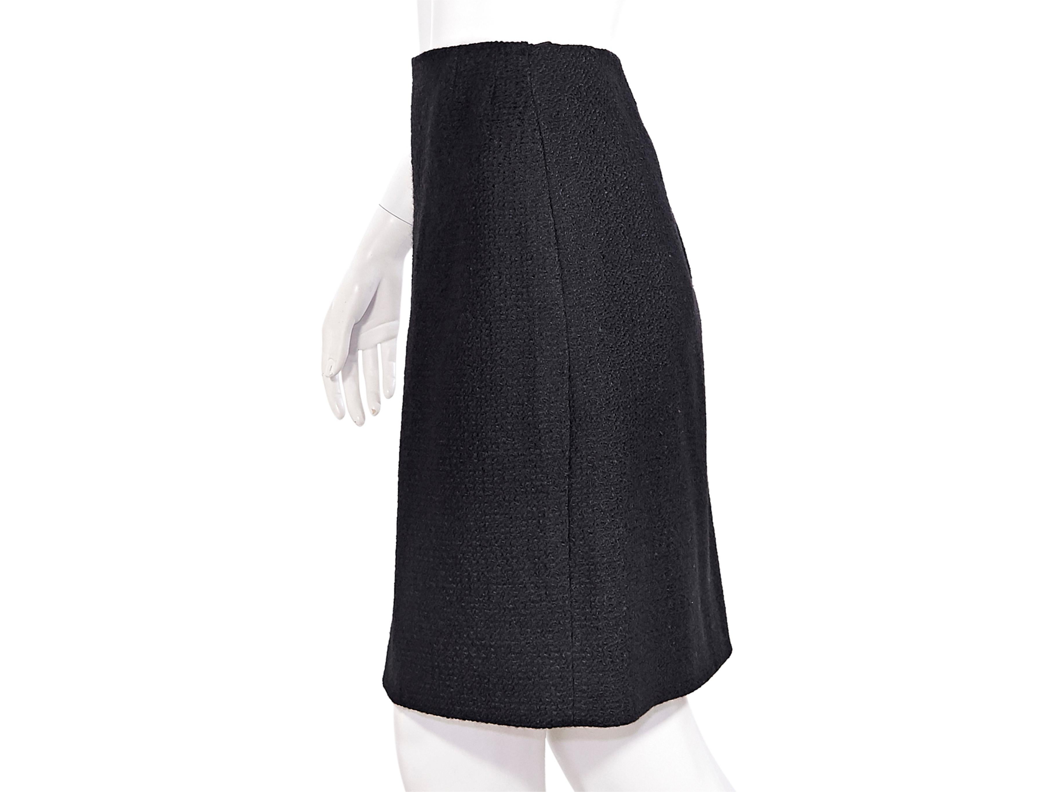 Product details:  Vintage black bouclé mini skirt by Chanel Creations. High-waist. Concealed zip back closure. Style yours with a polka dot-patterned top. 29