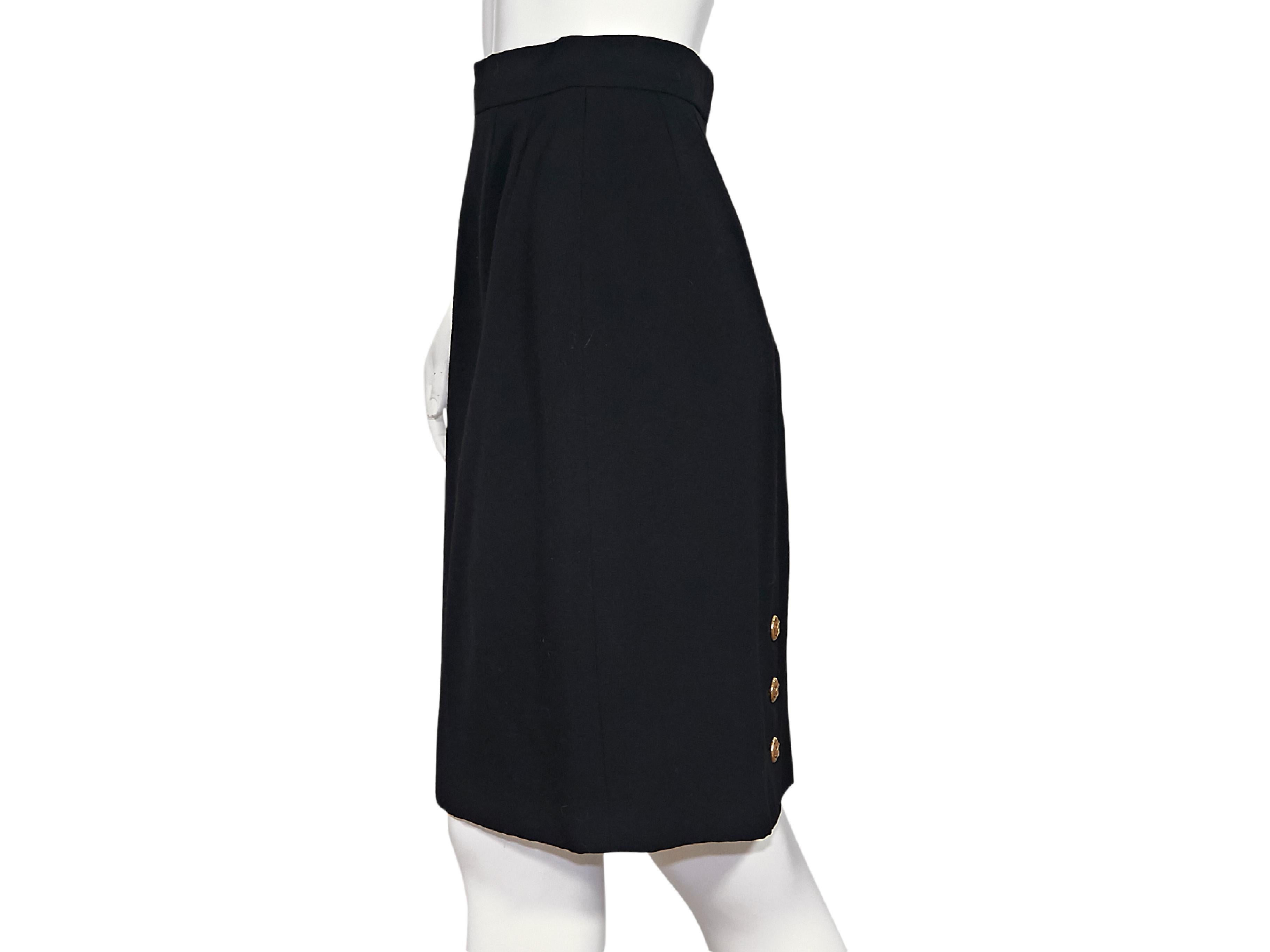 Product details:  Vintage black wool pencil skirt by Chanel.  Banded waist.  Concealed back zip and hook closure.  Back center hem with three-button detail.  Goldtone hardware.  27