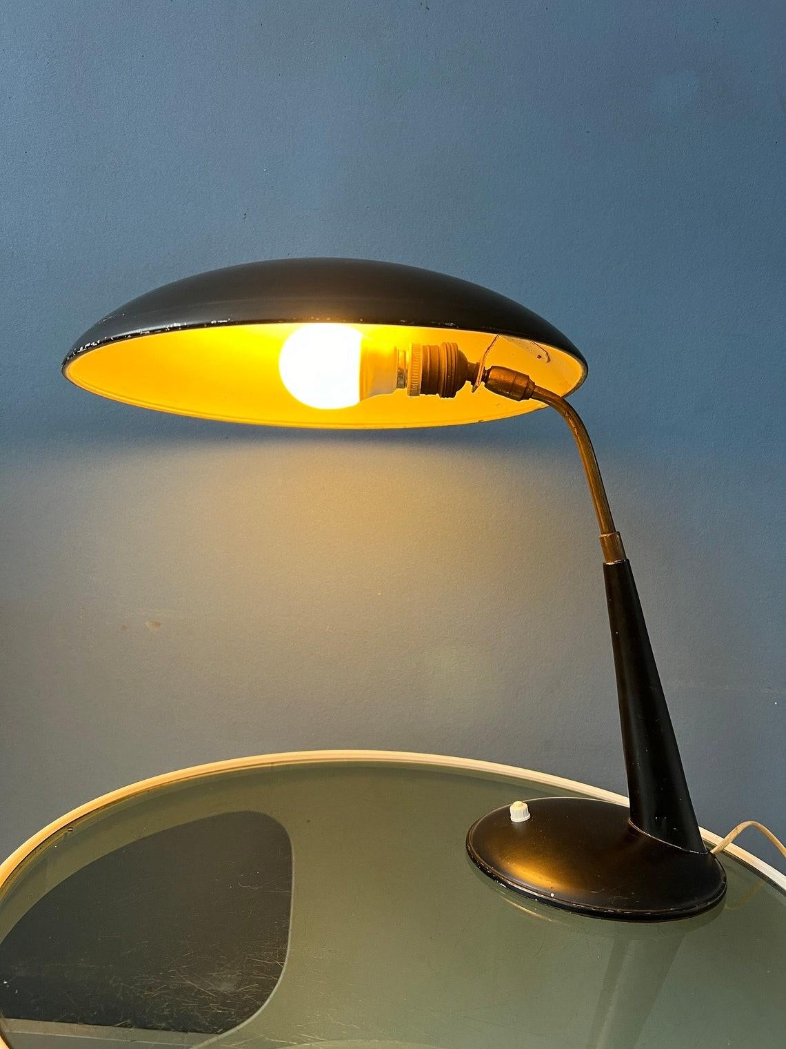 Black Christian Dell table lamp for Kaiser Leuchten. The lamp is made out of metal. The lamps has a switch on the base. It requires a E27/26 bulb and currently has a EU-plug (usable outside EU with plug-converter).

Additional