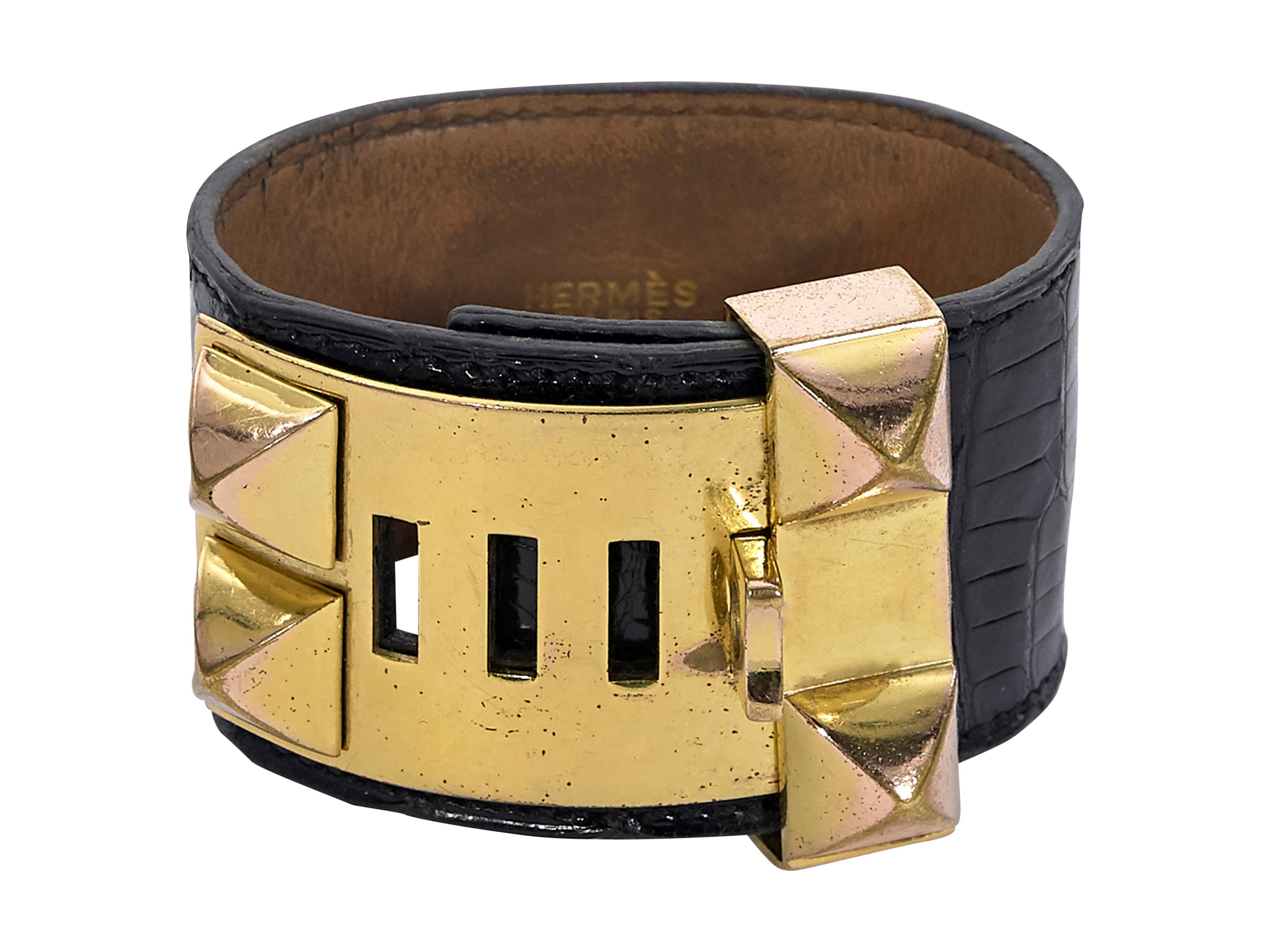 Product details:  Vintage black crocodile Collier de Chien bracelet by Hermes.  Adjustable clasp closure.  Goldtone hardware.  8