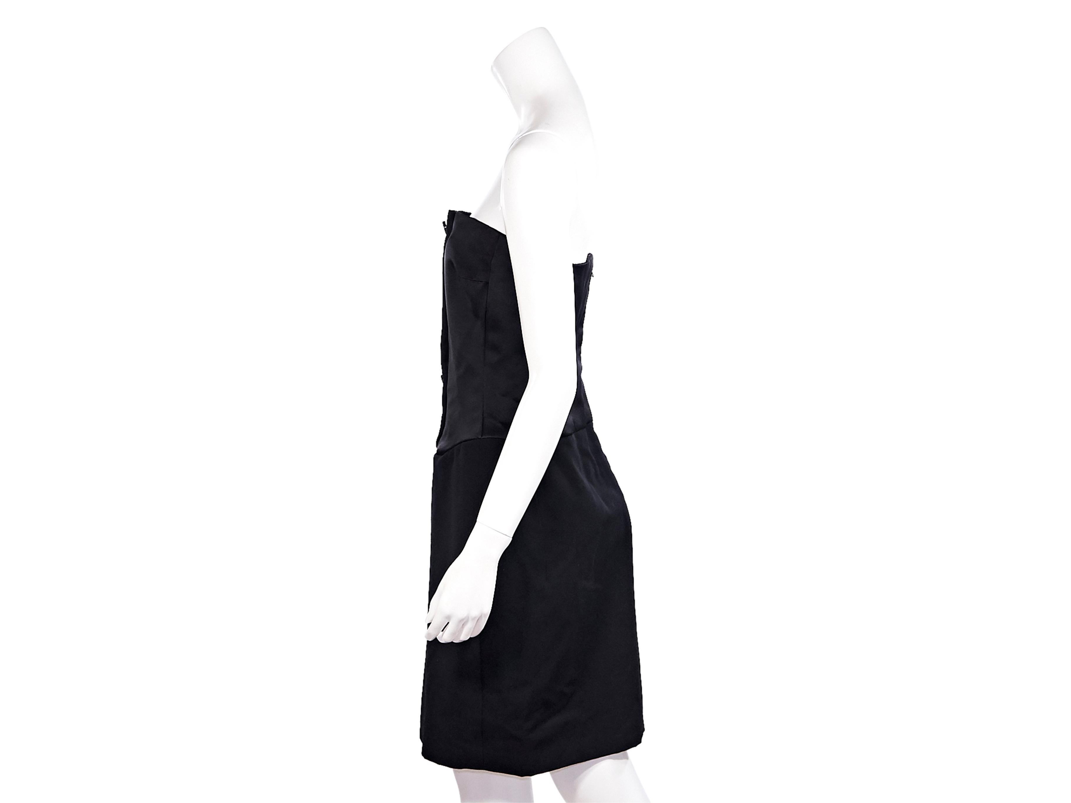Product details:  Vintage black strapless satin dress by Jacqueline de Ribes.  Double button accents at bodice.  Concealed back zip closure.  30