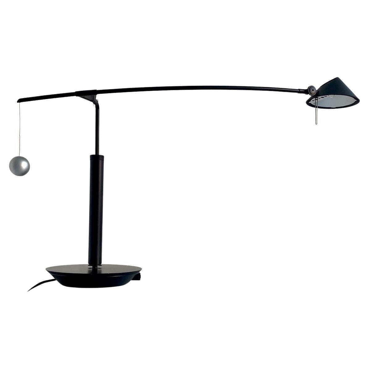 Beautiful lamp nestore lettura by Carlo Forcolini for Artemide, Italy 1991. 
Structure in black lacquered metal and plastic, counterweight ball in grey lacquered metal. 
The arm of the lamp is adjustable vertically and horizontally. 
Functional