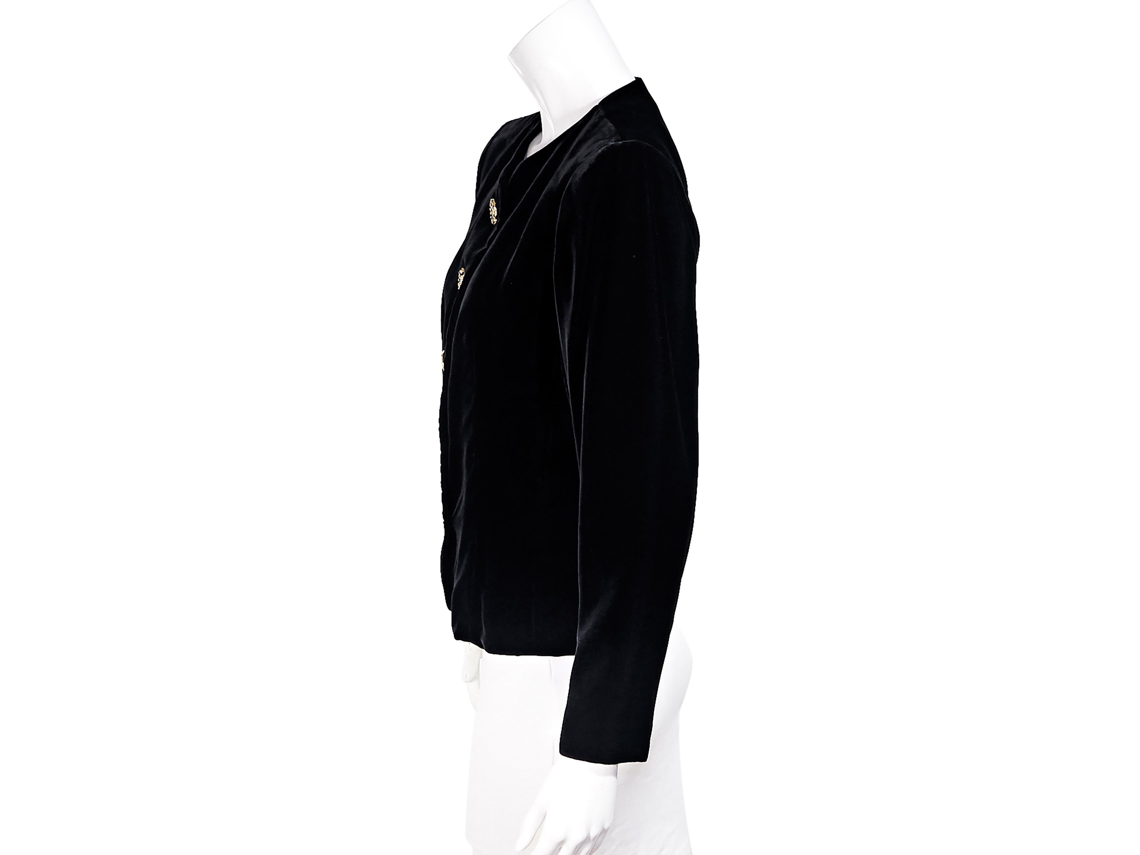 Product details:  Vintage black velvet jacket by Yves Saint Laurent Rive Gauche.  Crewneck.  Long sleeves.  Button-front closure set with crystals.  Goldtone hardware.  31