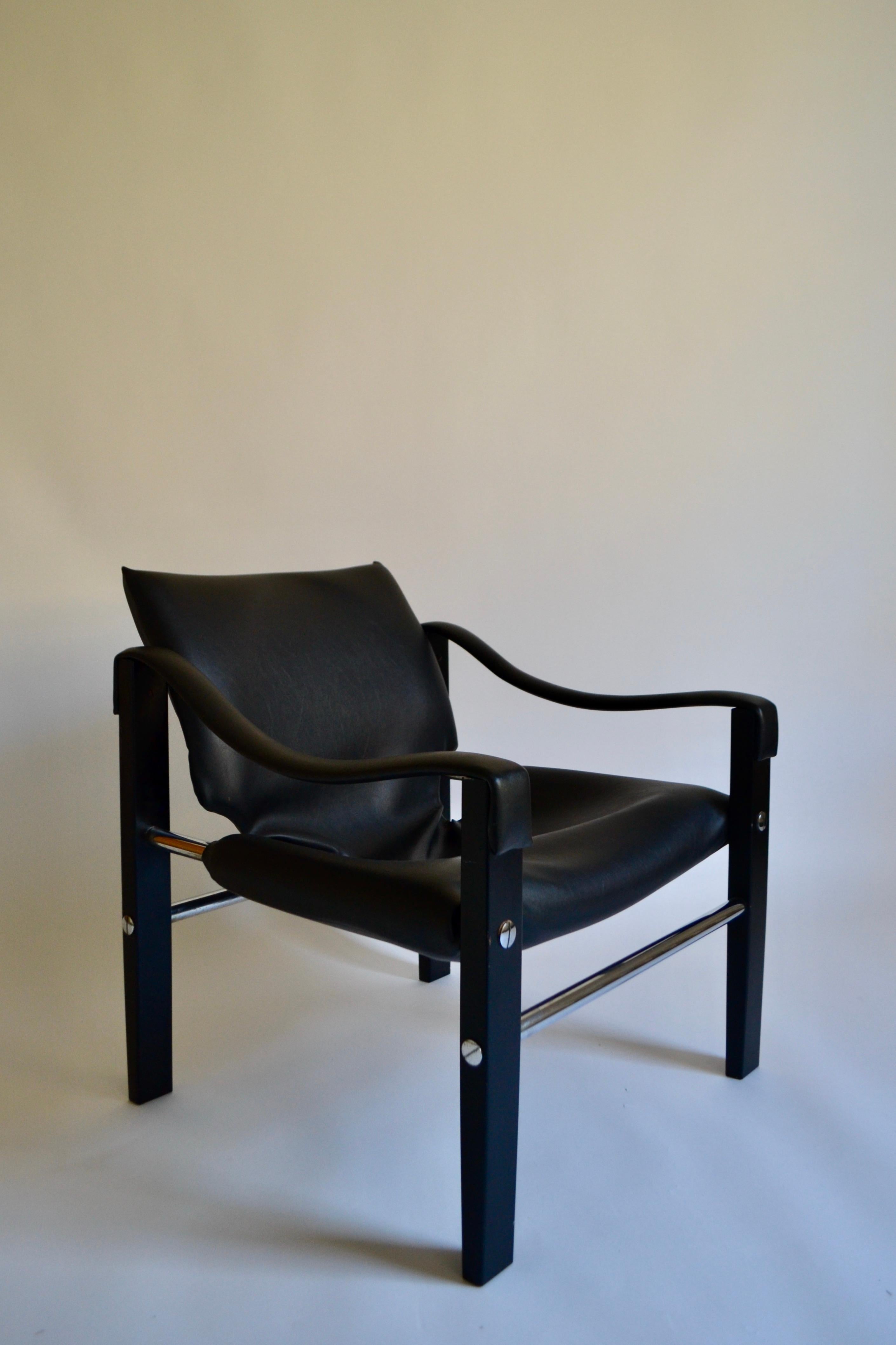 Black vinyl safari chair on metal frame designed by Maurice Burke for British furniture manufacturer Arkana in the 1980s. Original vinyl upholstery in excellent condition with small scuffs to metal legs as pictured. Makers stamp embossed to