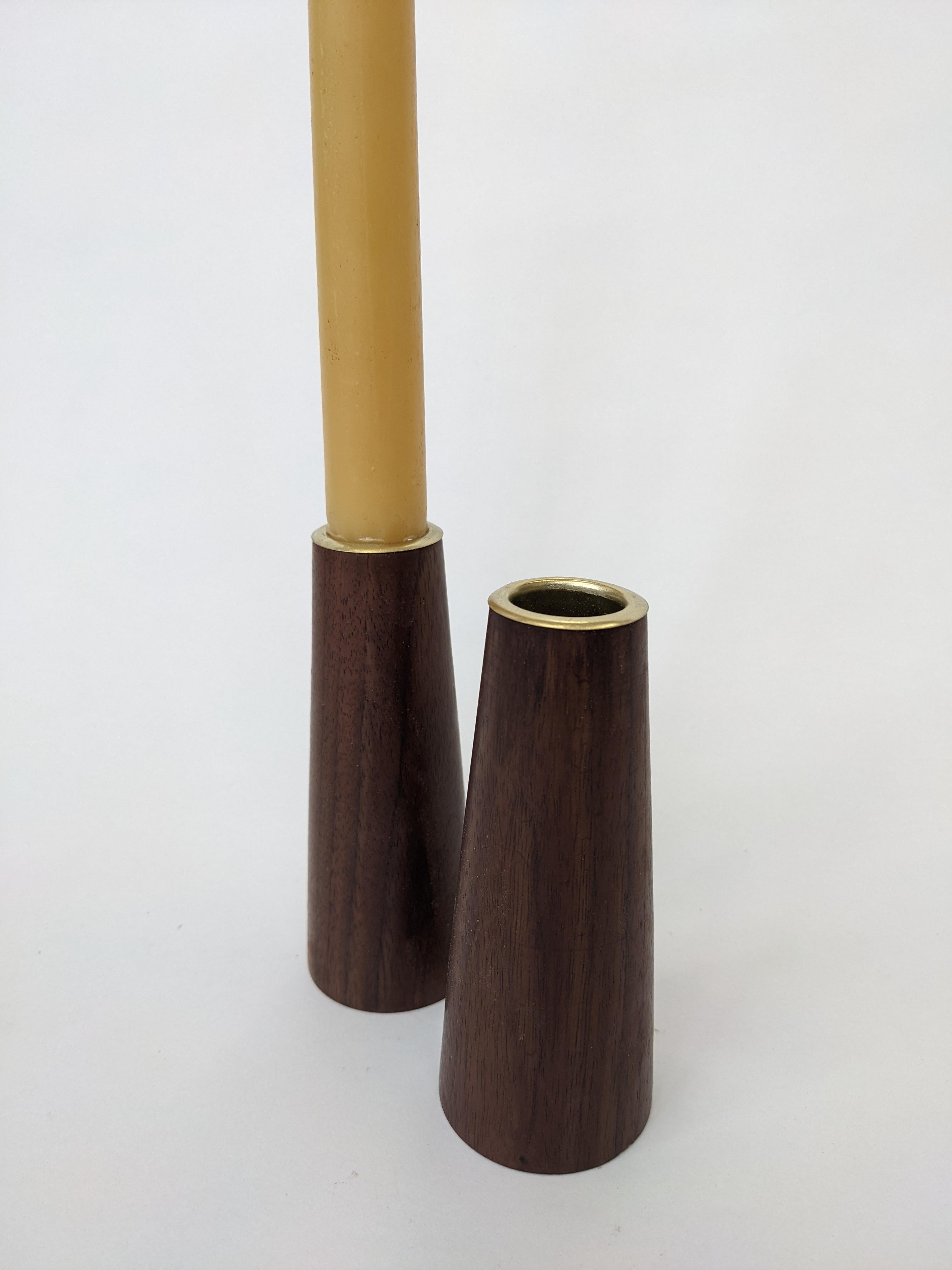 Black Walnut candlesticks with brass ferrules. 
Elegant, hand crafted, perfect for the holiday season, or to warm up any space.

This item is designed by Fuugs and made from salvaged trees, milled by us, dried and crafted into furniture by hand in