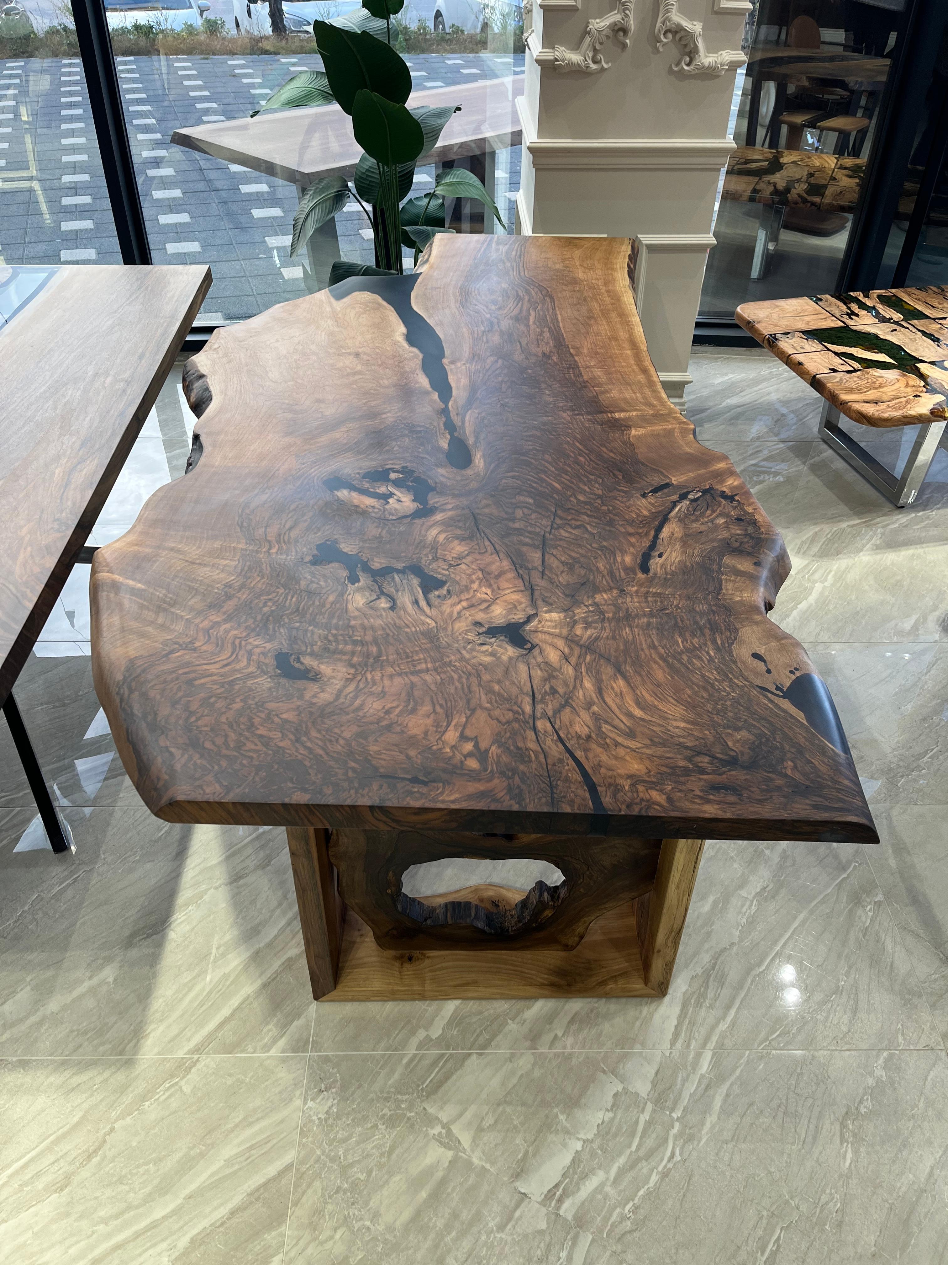 LIVE EDGE WALNUT TABLE

This table is made of natural walnut slabs. 

Some Walnut slabs have a lot of natural beauty as it’s one side has a large curve. This is one of them! 

We've filled the cracks with black epoxy, without disrupting naturalness