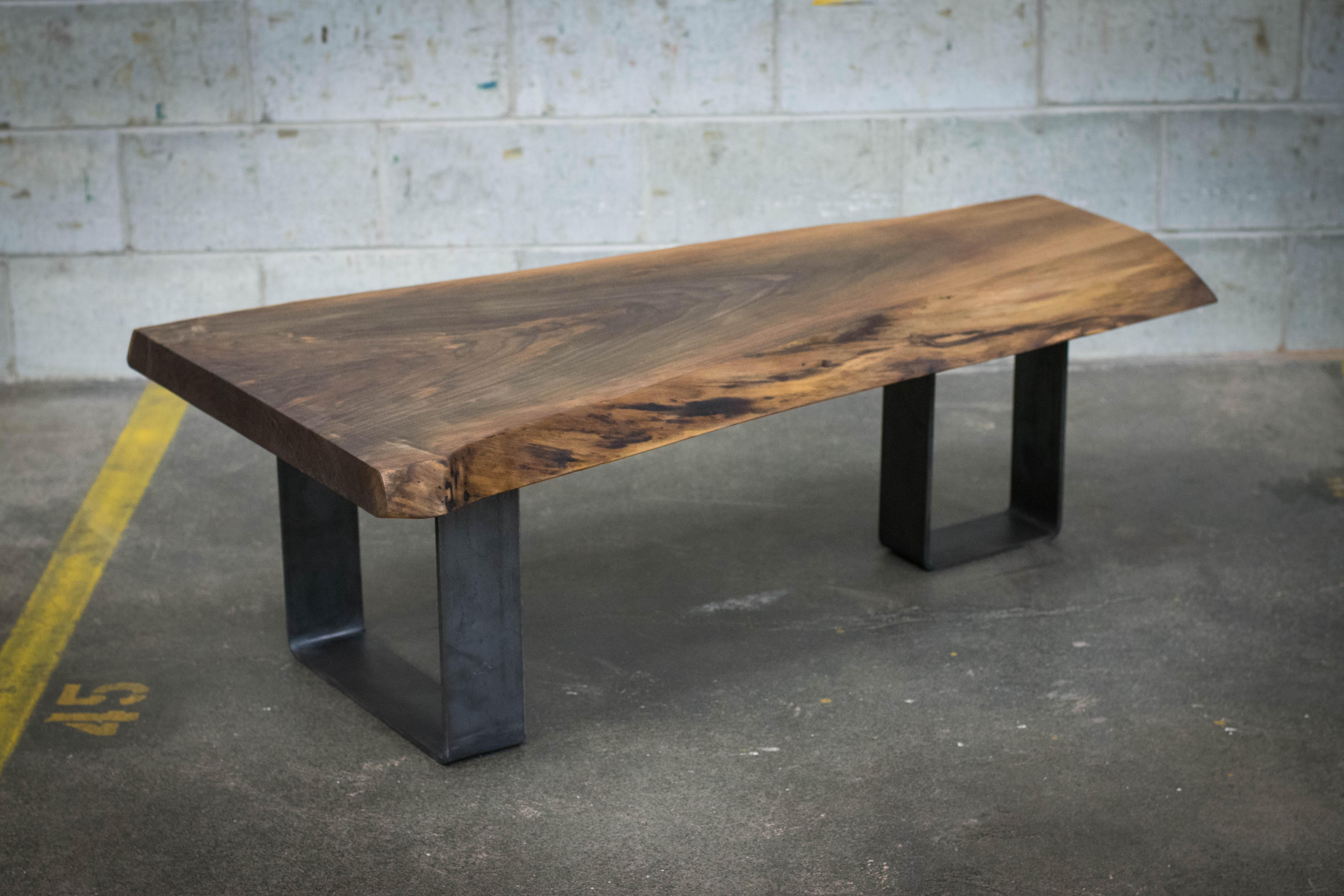 This black walnut coffee table uses a single live edge slab. This coffee table is made to order. The legs are made using steel flat bars 3in wide so even perpendicular, the table is very stable. Keep in mind we can offer any style of base. We offer