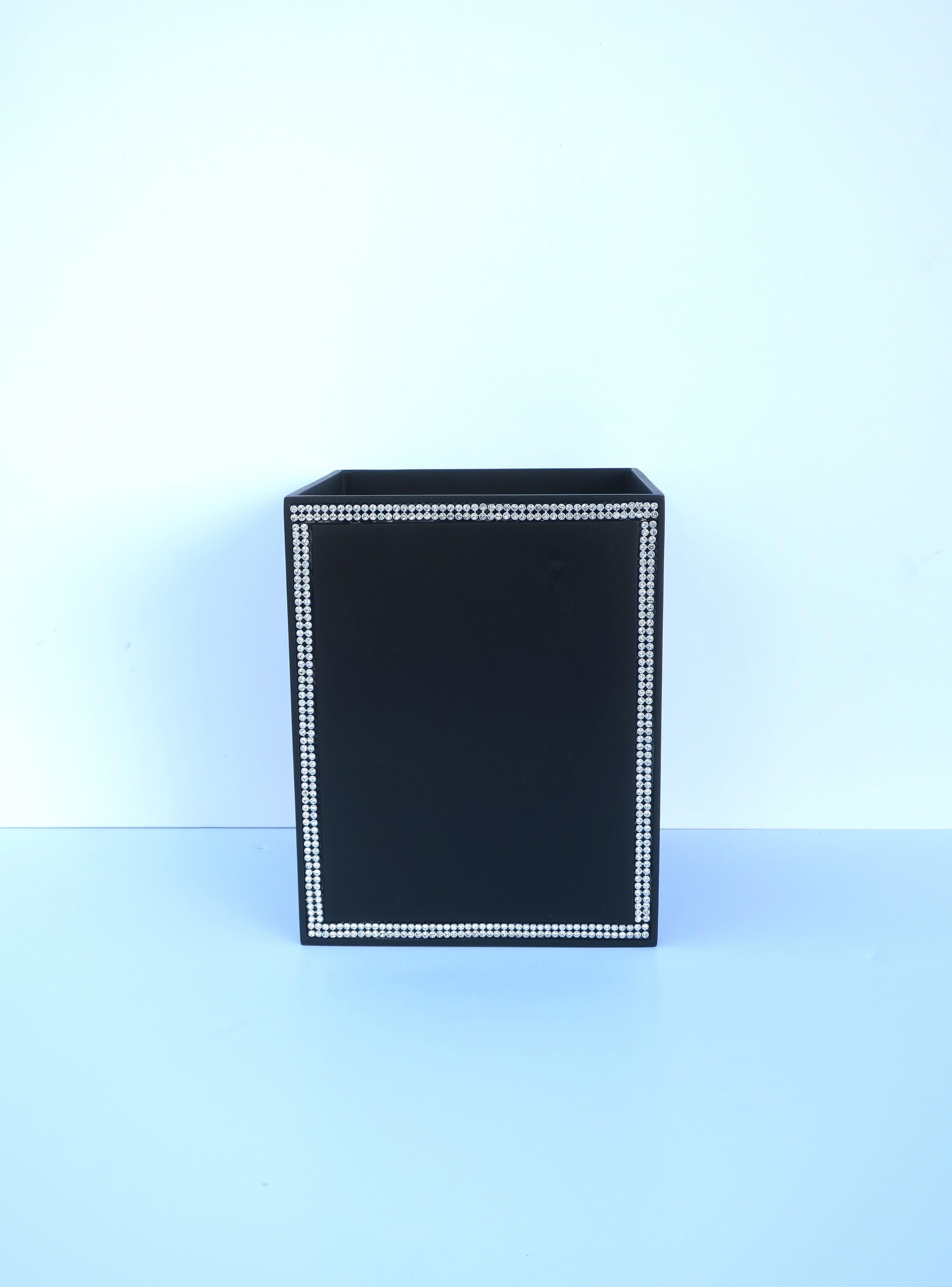A black wastebasket or trash can with faux-diamond design. Trash can is a black powder-coated metal with faux diamond design on two sides. Piece has never been used. A great piece for a bathroom, powder room, office, walk-in closet, etc. Very good