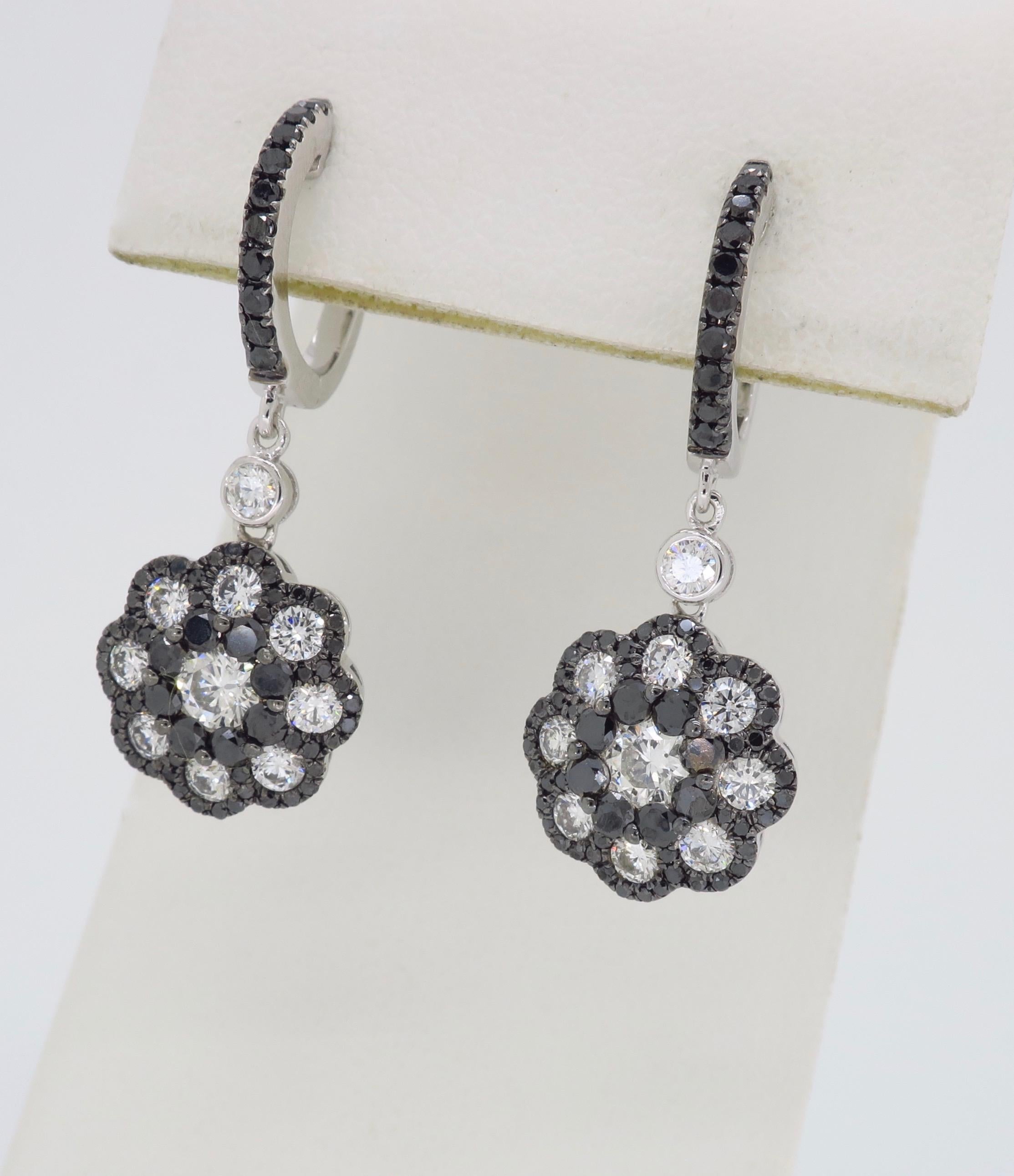 Floral designed black and white diamond dangle earrings crafted in white gold.

Diamond Carat Weight: Approximately 2.21CTW 
Diamond Cut: Round Brilliant Diamonds
Color: 134 Black Diamonds, 20 with Average G-I in color
Clarity: Average SI
Metal: 14K