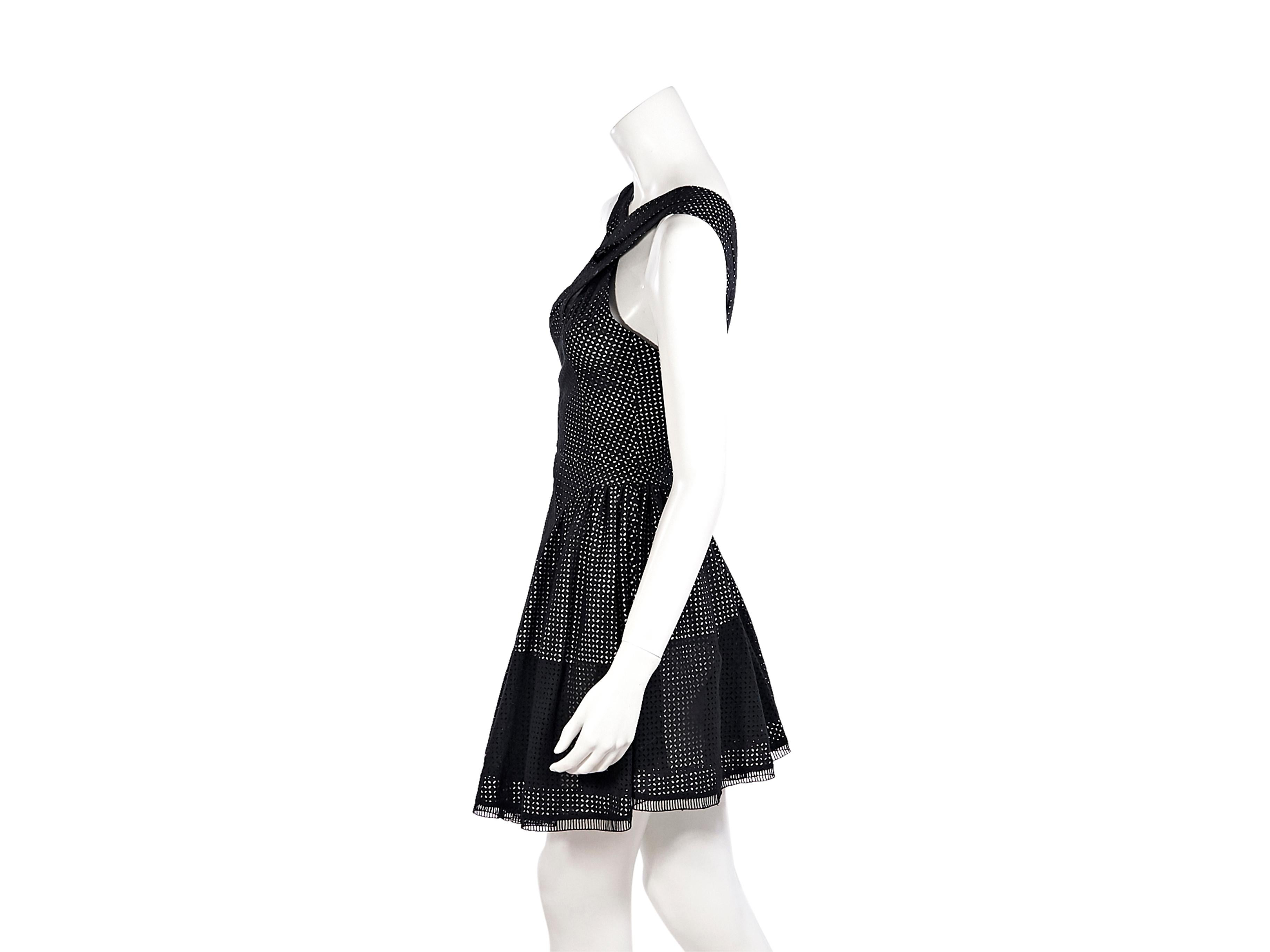 Product details:  Black and white eyelet cotton fit-and-flare dress by Alaia.  V-neck.  Sleeveless.  Concealed back zip closure.  Label size FR 36.  32