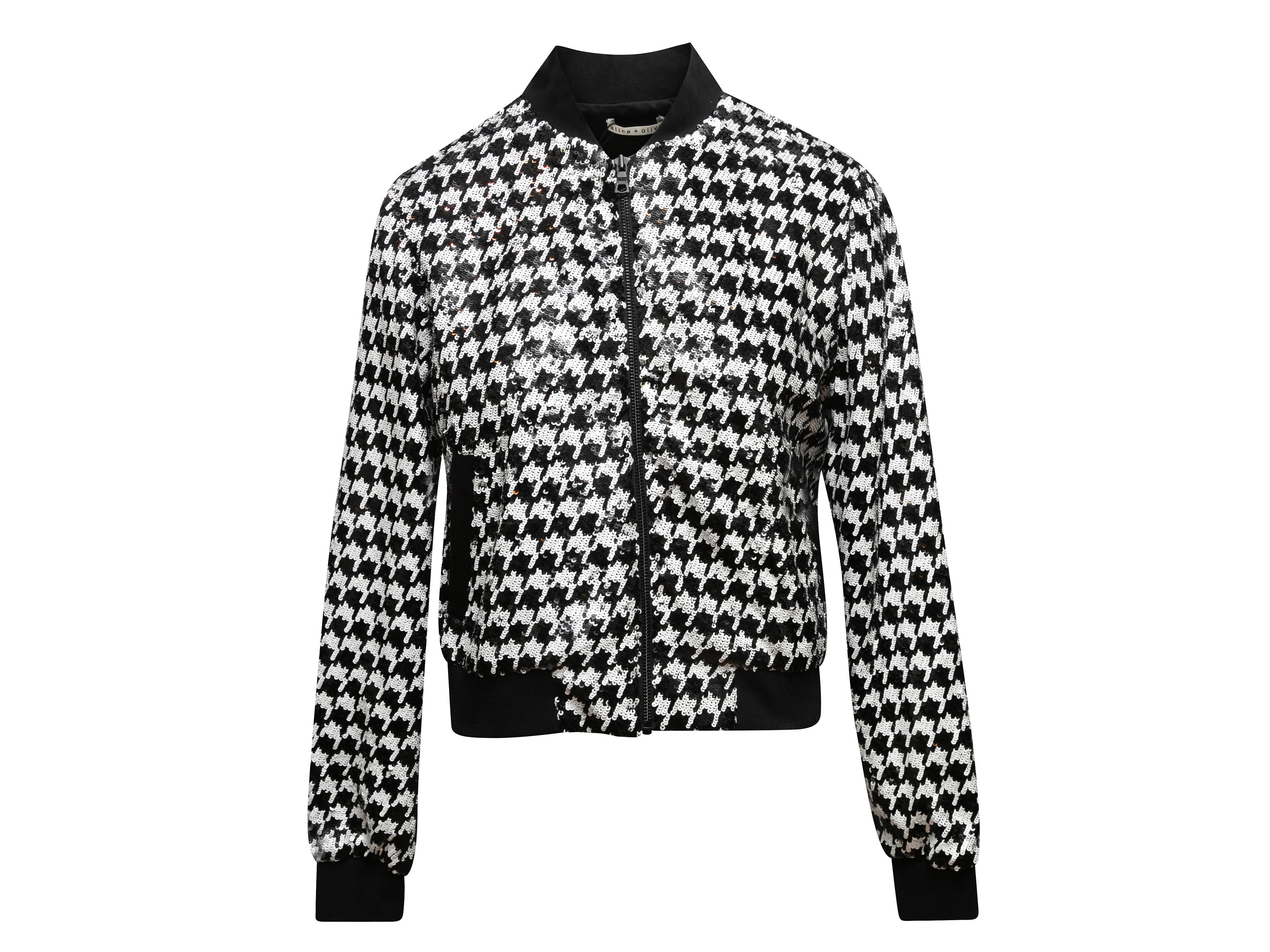 Black and white sequined houndstooth patterned jacket by Alice + Olivia. Dual hip pockets. Zip closure at center front. 38