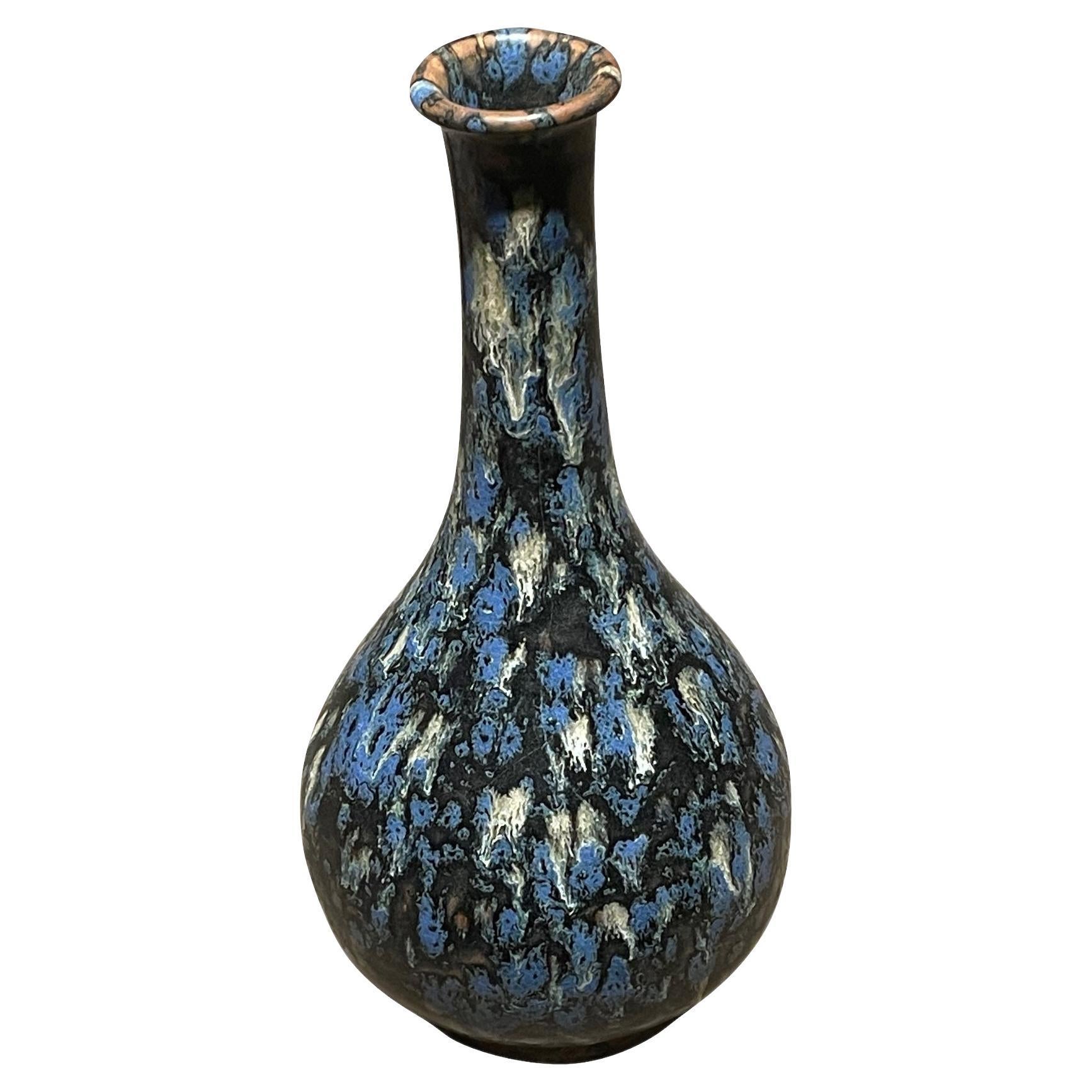 Contemporary Chinese tall thin neck vase with black, blue and white splatter glaze.
One of several from collection of similar glaze in various shapes.
