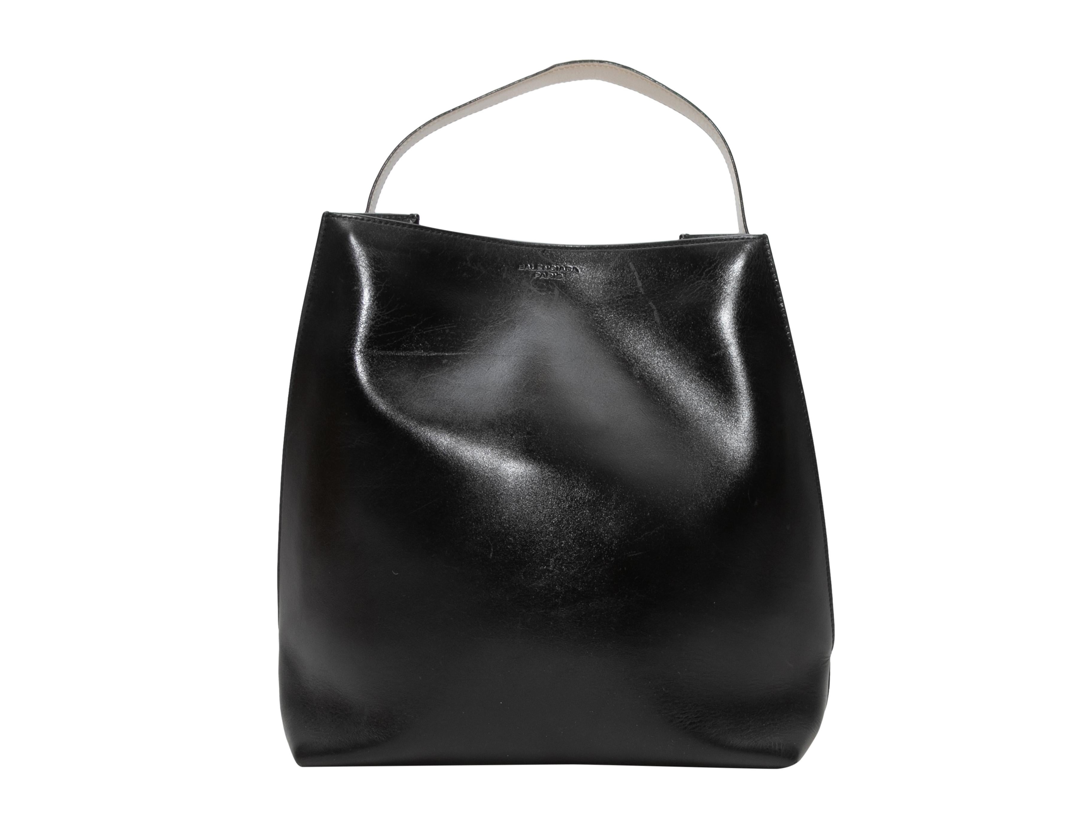  Black & White Balenciaga Everyday Bucket Tote Bag. The Everyday Bucket Tote Bag features a leather body, silver-tone hardware, and a single flat top handle. 14.5