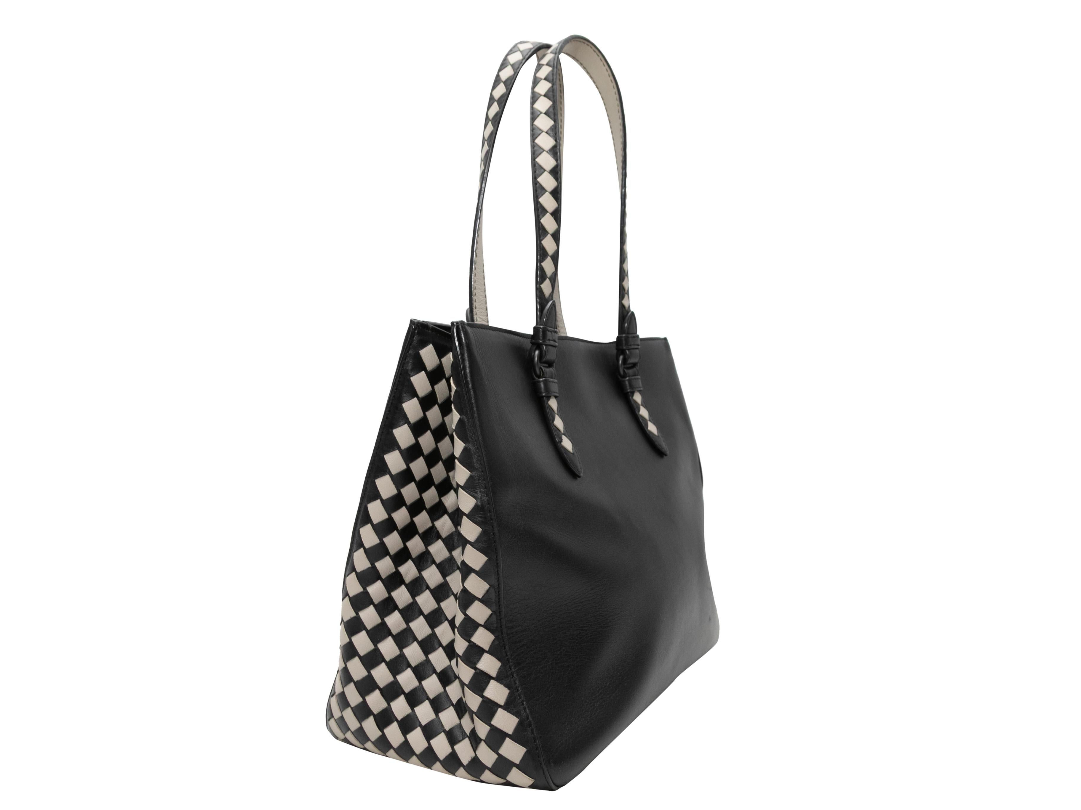 Product Details: Black & White Bottega Veneta Intrecciato & Leather Tote Bag. This tote features a leather body, dual flat Intrecciato straps, and Intrecciato side and bottom panels. 12