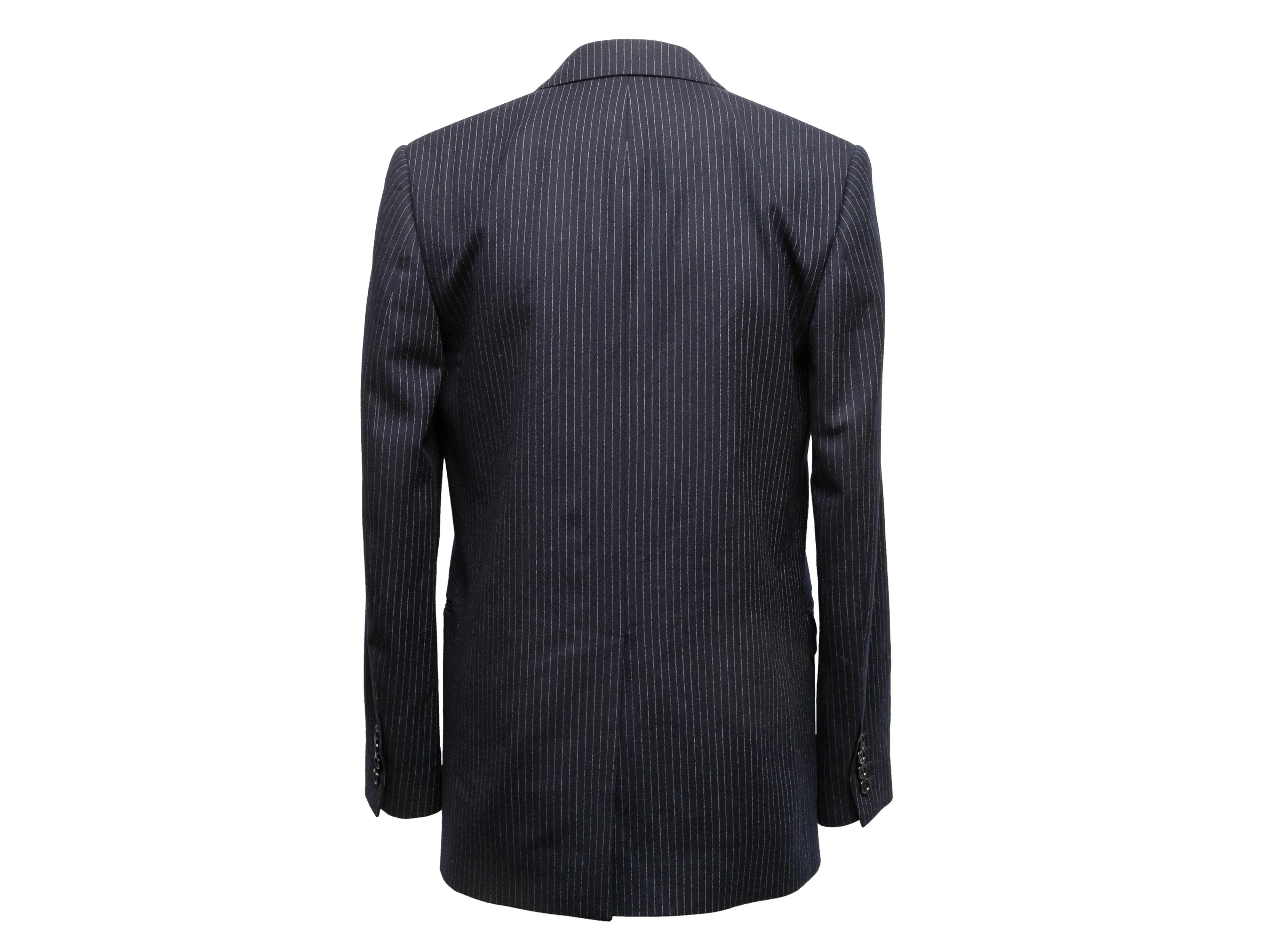 Black and white pinstriped double-breasted blazer by Celine. From the Hedi Slimane Era. Peaked lapel. Three pockets. Button closures at front. 32