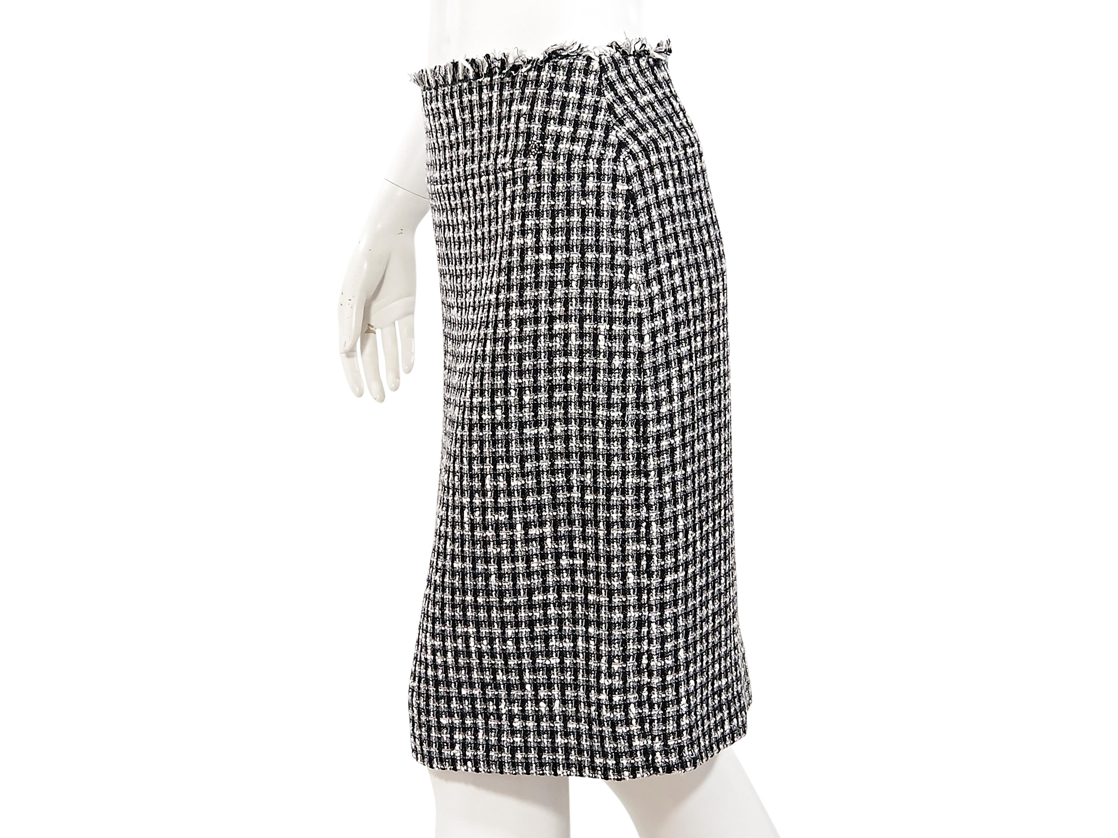 Product details:  Black and white boucle wool-blend pencil skirt by Chanel.  Frayed waist trim.  Concealed back zip closure.  Back center hem vent.  28