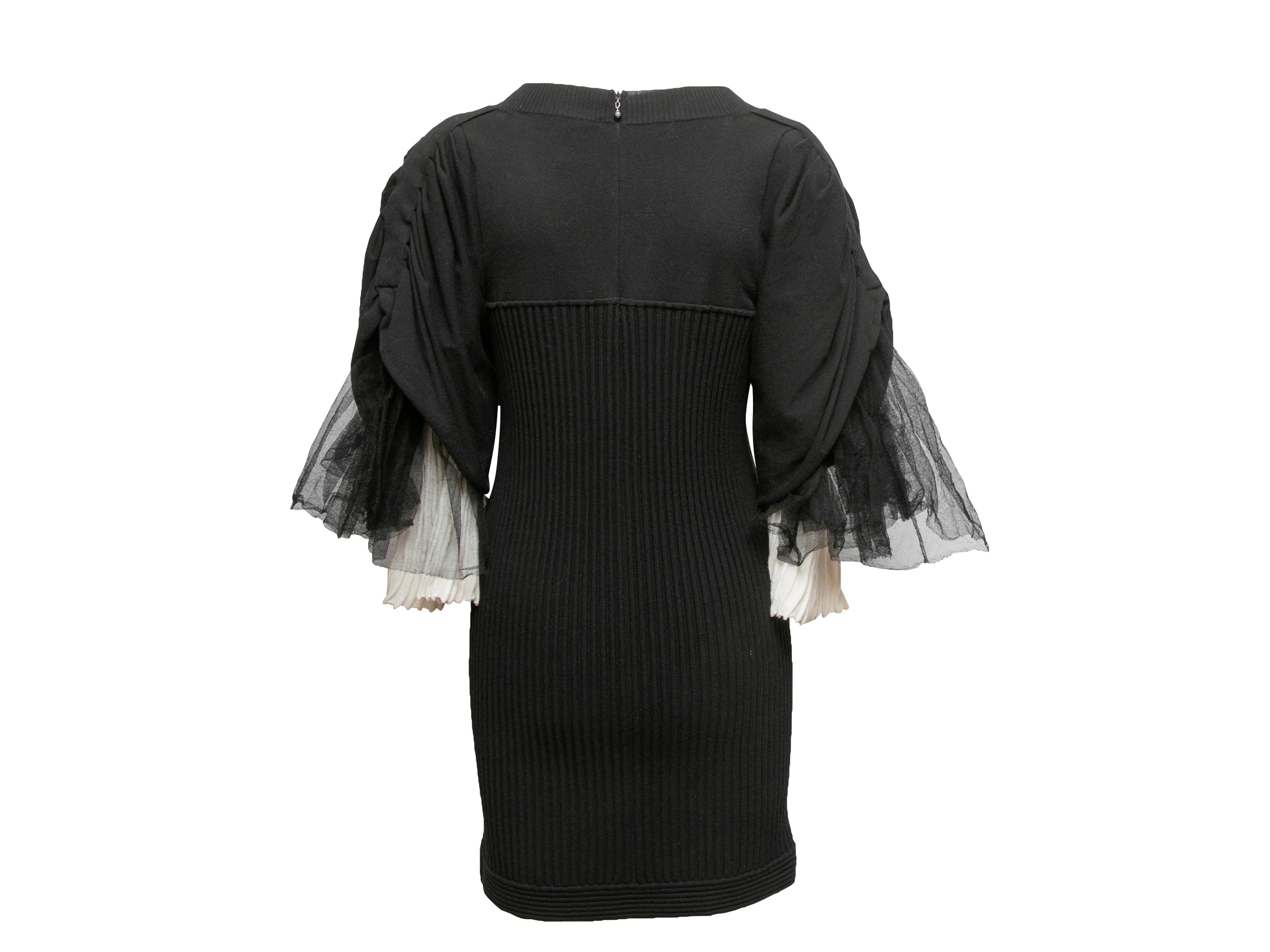 Schwarz-weißes geripptes Minikleid von Chanel. Circa 2009. V-Ausschnitt. Kurze Ärmel mit plissiertem Tüllbesatz. Reißverschluss in der hinteren Mitte. 32