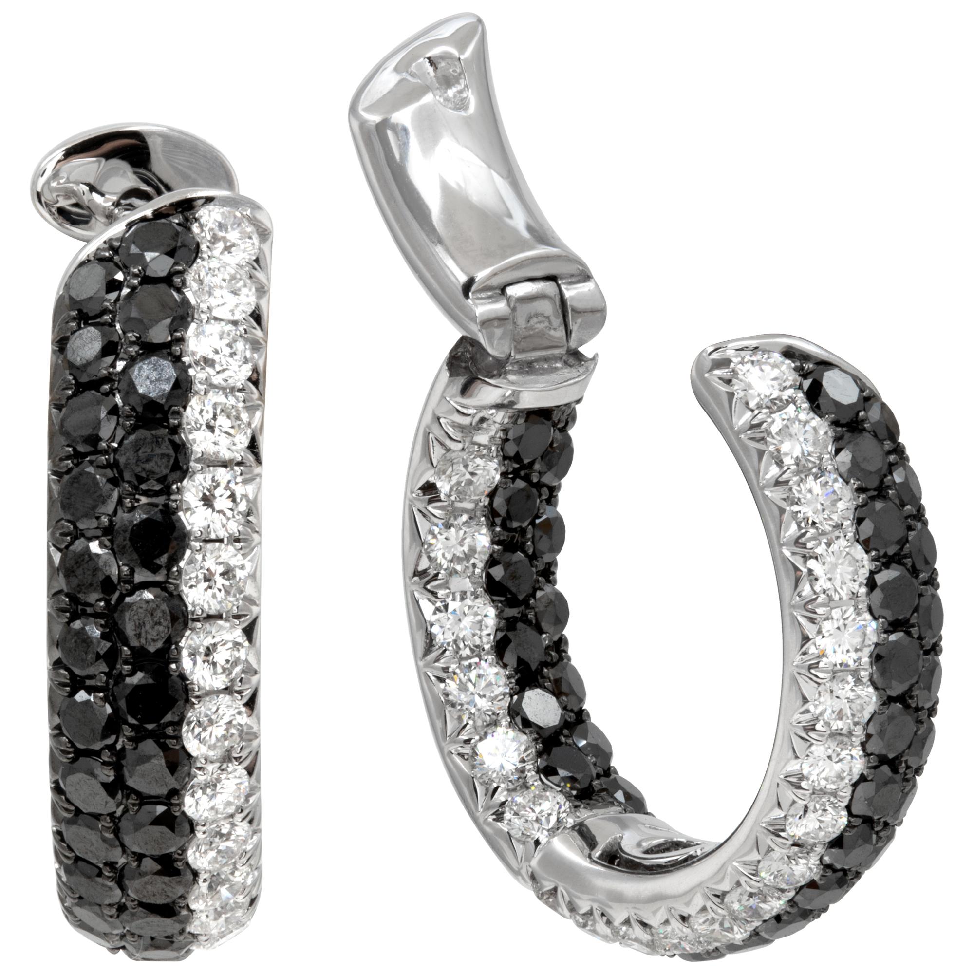 Black & white diamond hoop earrings in 18k white gold with approximately 2.30 carats in white diamonds and 1.10 carats in black diamonds. 7/8 inch diameter (21mm).