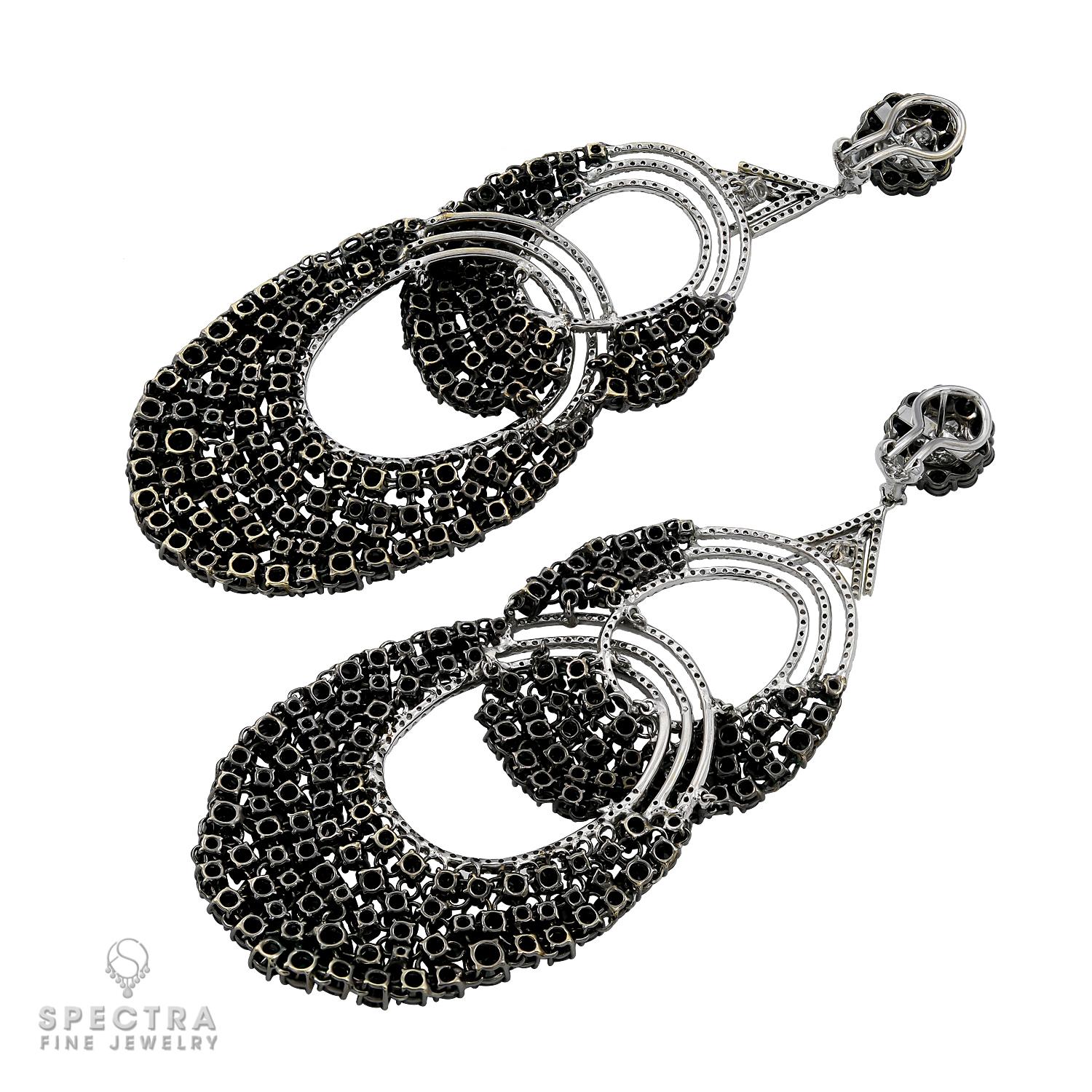 Beautiful chandelier earrings embellished with black and white natural diamonds. 
18k white gold, gross weight 55.24 g.
The earrings are 4.33 inch long (11 cm).