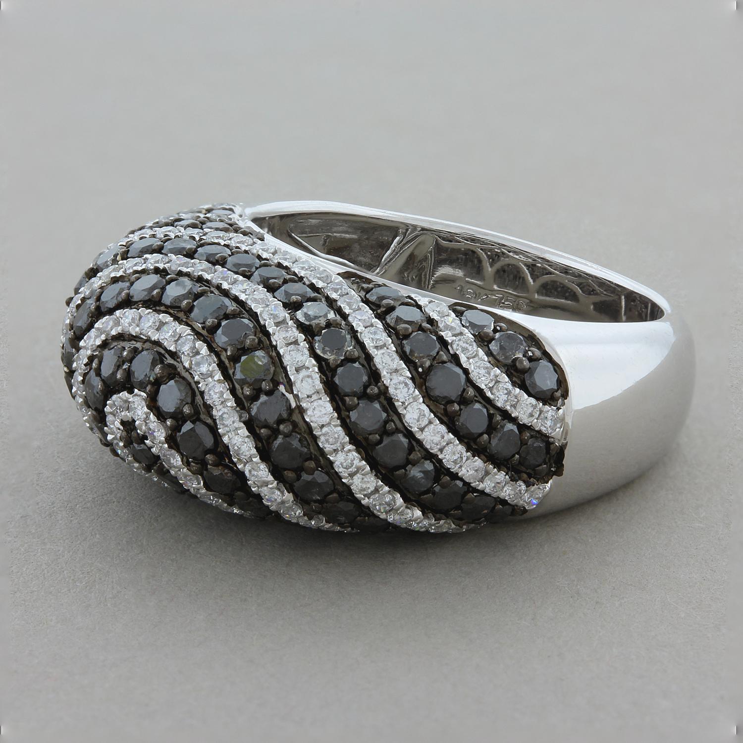 This domed cocktail ring features 2.11 carats of black diamonds alternating with swirls of 1.06 carats of white diamonds. The round cut diamonds are set in 18K white gold with a black rhodium finish to accentuate the black diamonds.

Ring Size 7.25