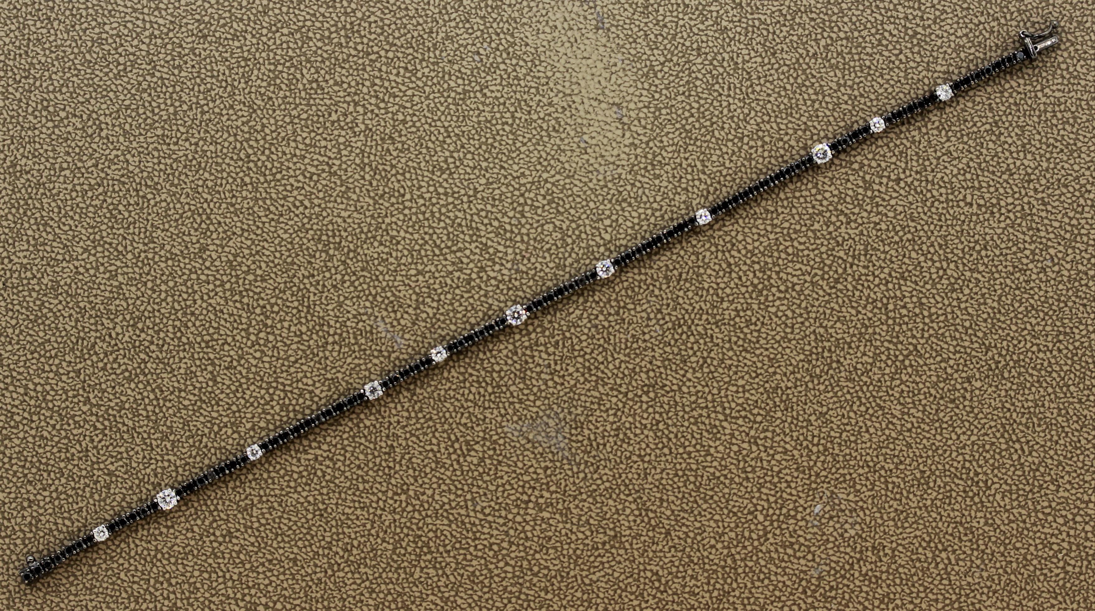 A thin and comfortable tennis bracelet featuring black and white diamonds. There are 0.74 carats of white round brilliant cut diamonds along with 1.59 carats of black diamonds. Set in 18k gold with a rhodium finish that gives the piece a unique