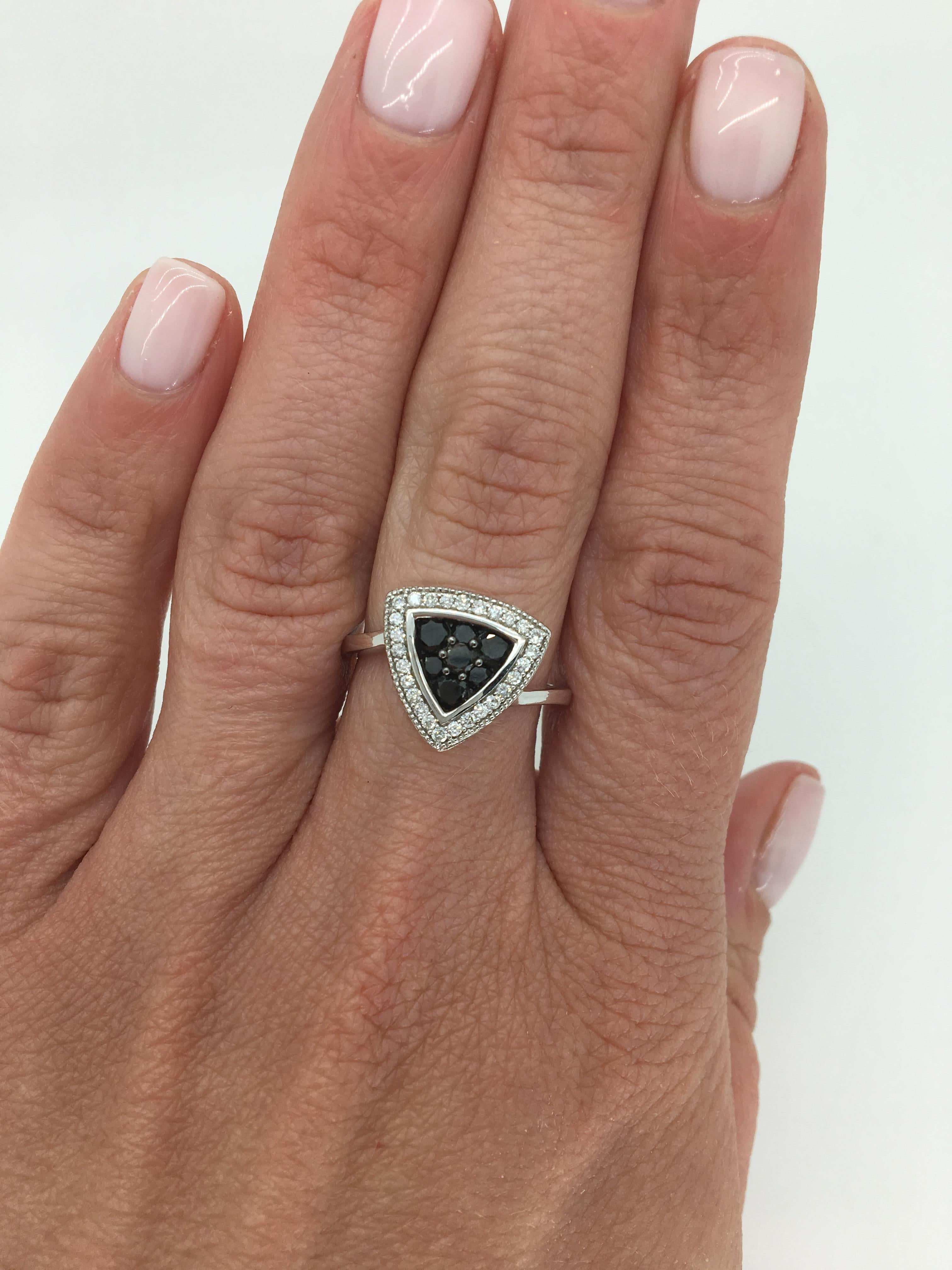 Triangular shaped black and white diamond ring crafted in 14K white gold.

Diamond Carat Weight: Approximately .64CTW
Diamond Cut: Round Brilliant Cut
Color: 27 with Average G-H and 7 that are Black in color
Clarity: Average I
Metal: 14K White