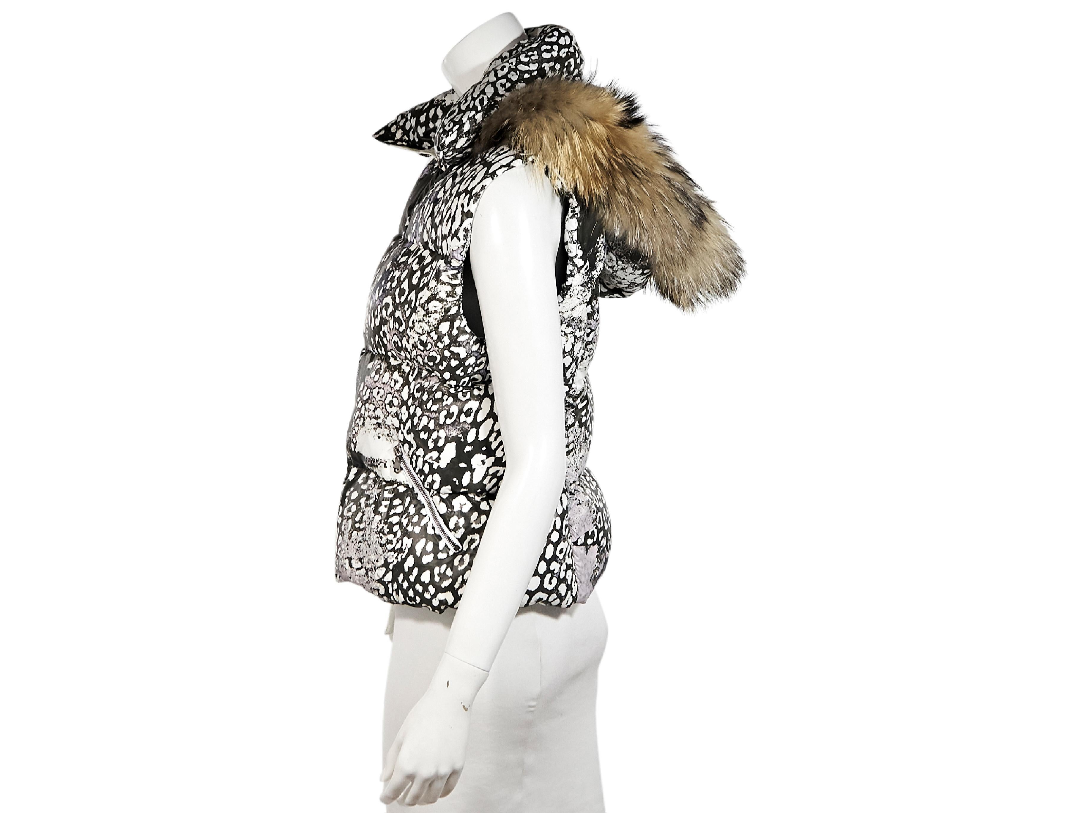 Product details:  Black and white animal-printed down vest by Emilio Pucci.  Stand collar.  Marmot fur-trimmed hood.  Zip-front closure.  Waist zip pockets.  38