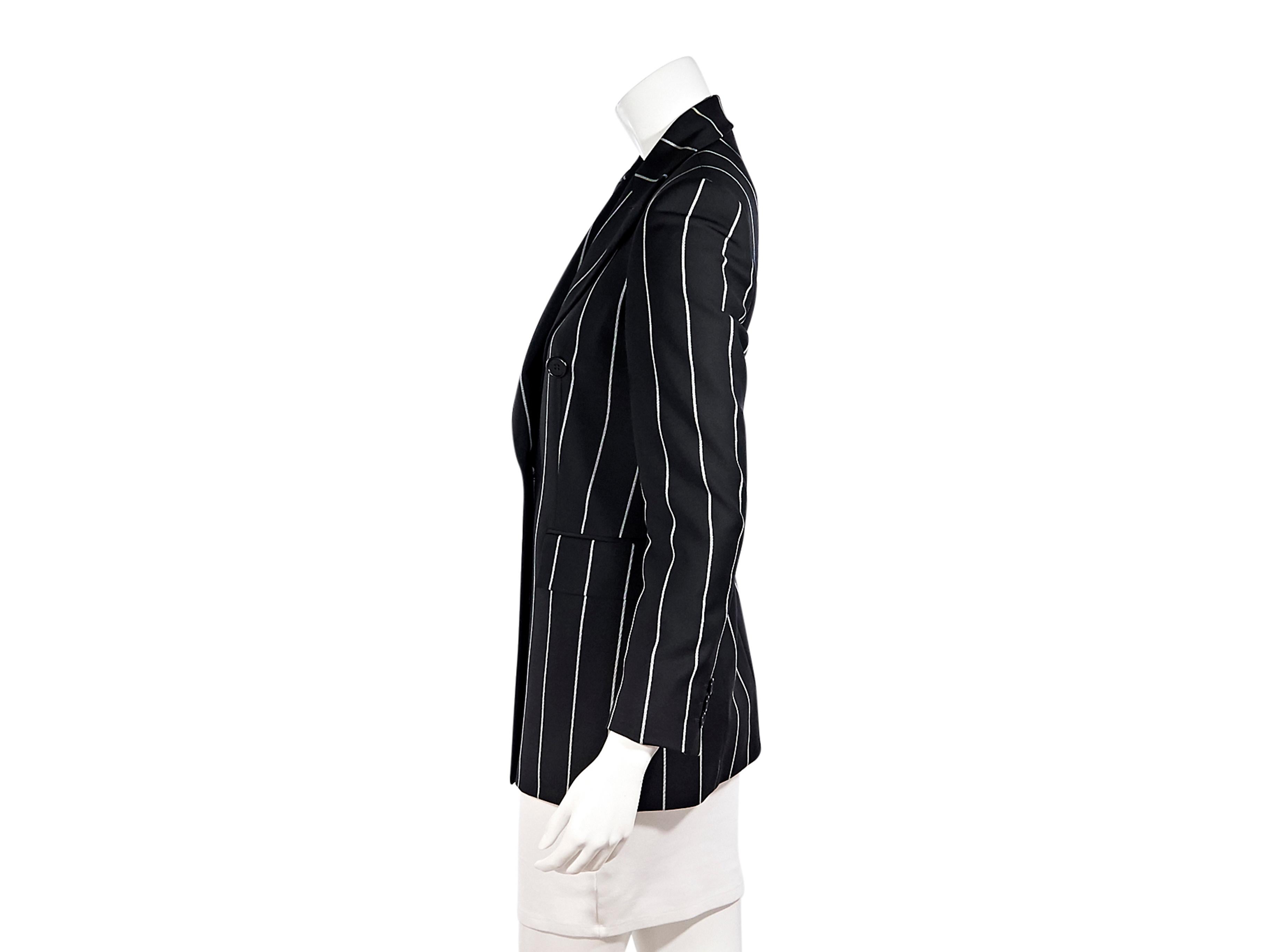 Product details:  Black and white striped blazer by Gianfranco Ferre.  Peak lapel.  Long sleeves.  Three-button detail at cuffs.  Double-breasted button-front closure.  Waist flap pockets.  32