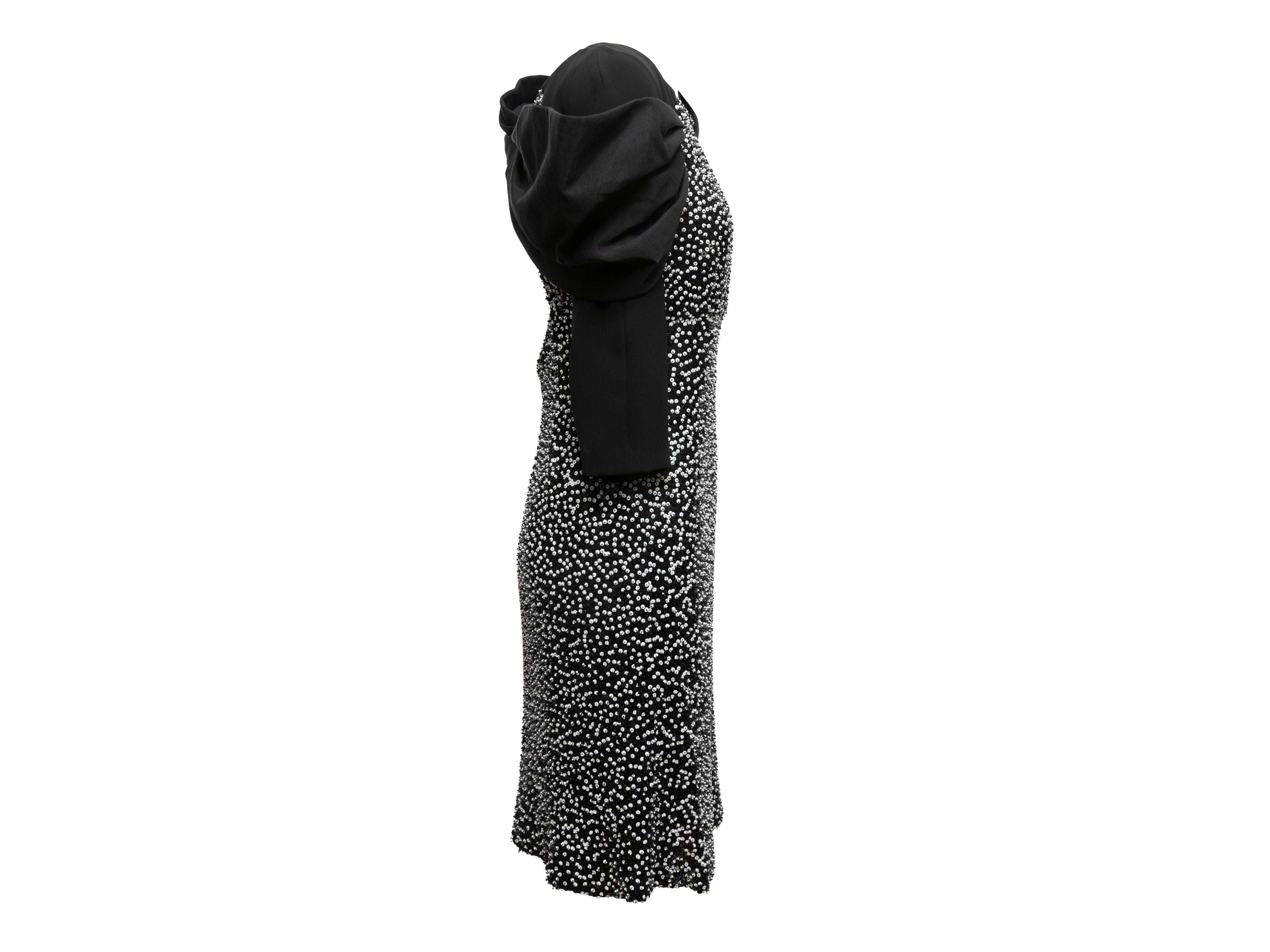 Black and white sequined bow dress by Giorgio Armani. Crew neck. Three-quarter sleeves. Oversized bow accent at back. 34